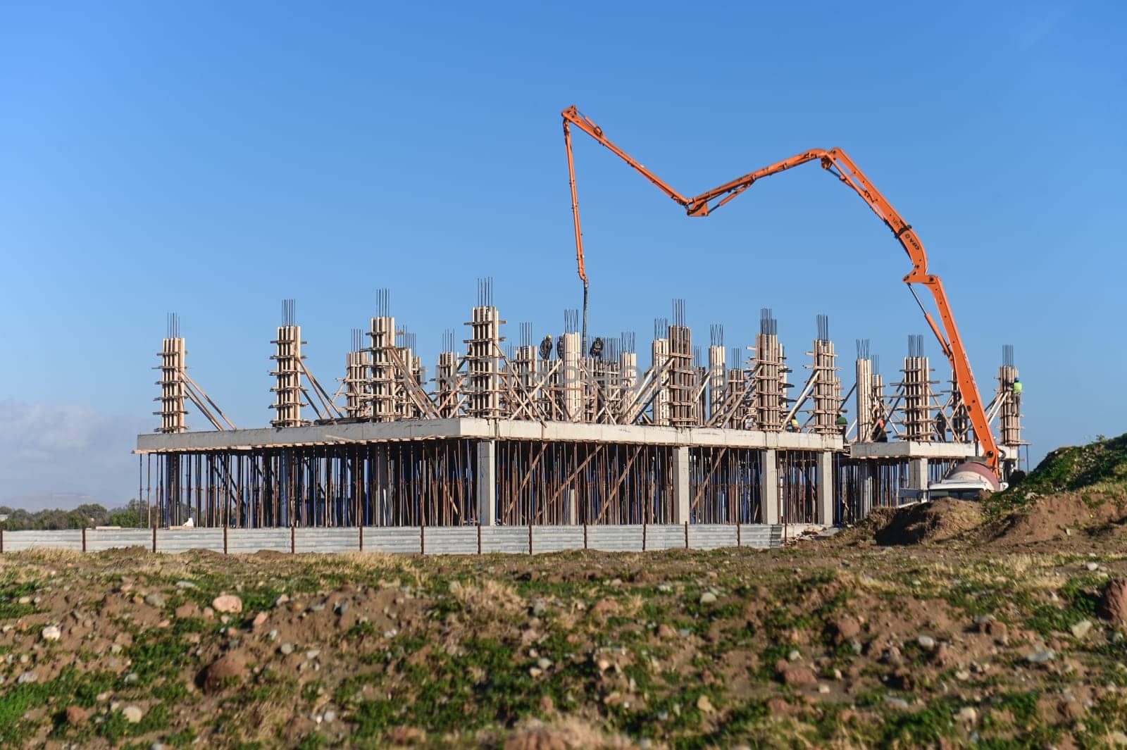 machine for pouring concrete at the construction site of a new complex near the sea 4