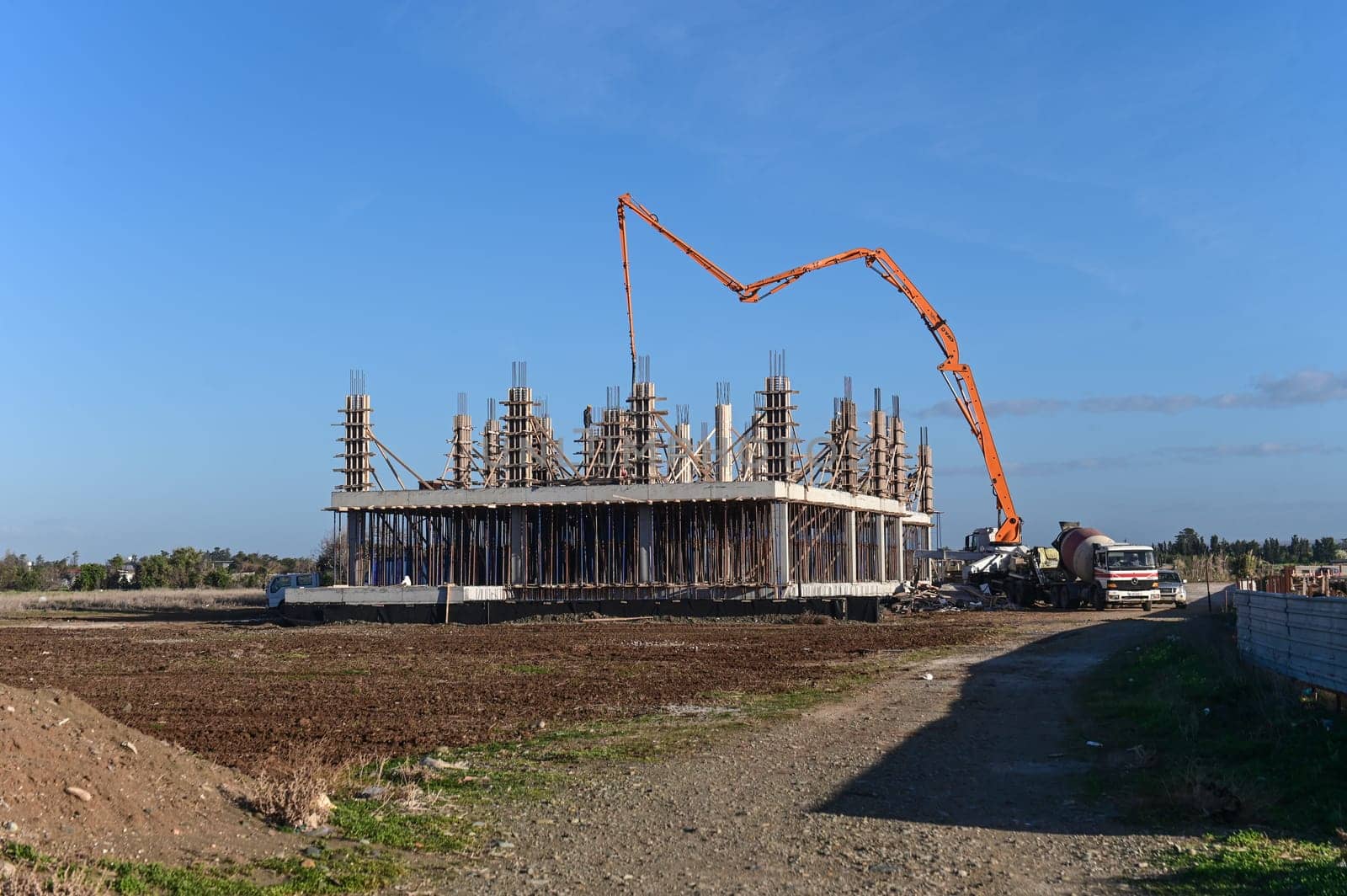 machine for pouring concrete at the construction site of a new complex near the sea