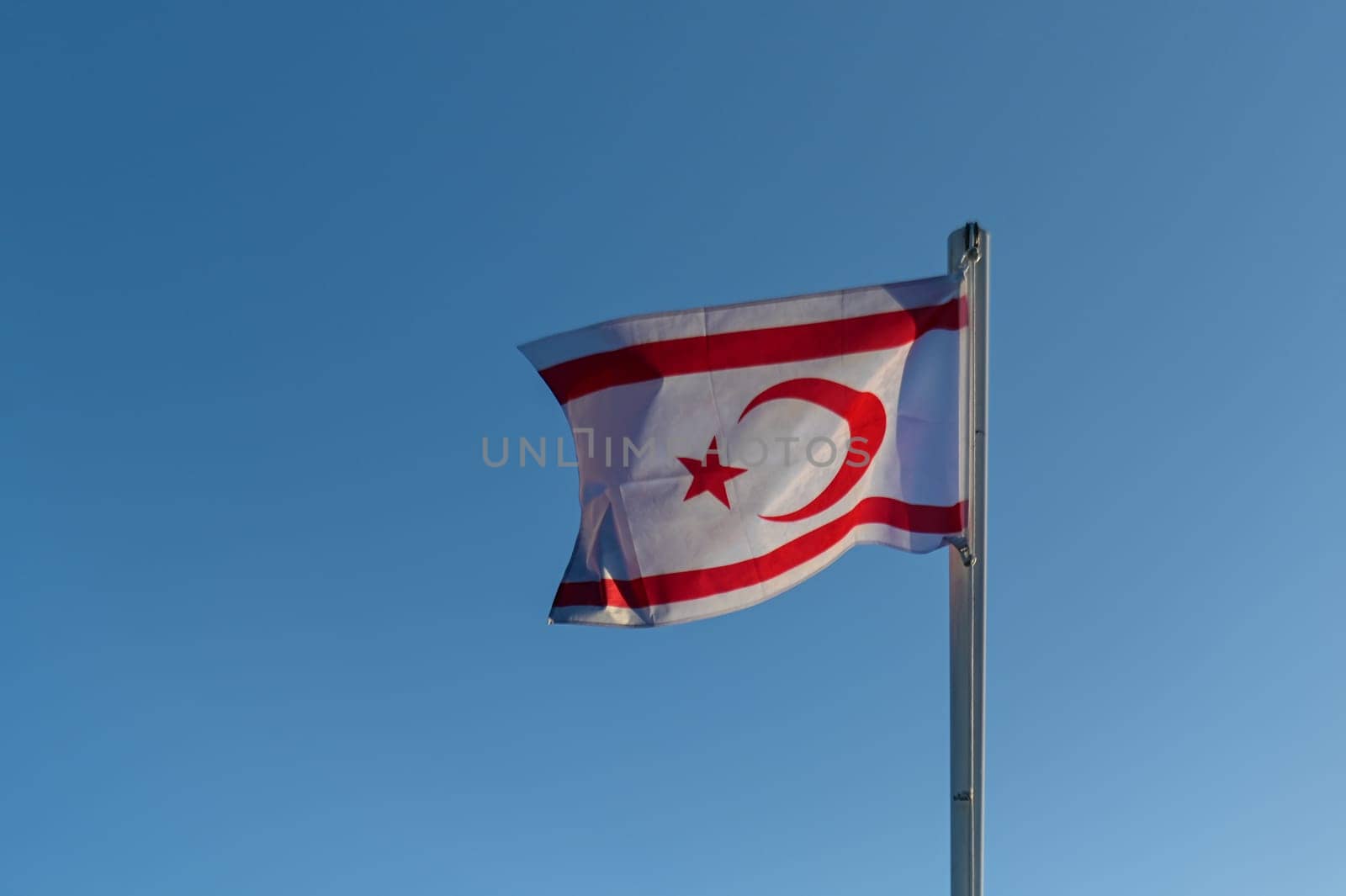 flag of the Turkish Republic of Northern Cyprus against the blue sky