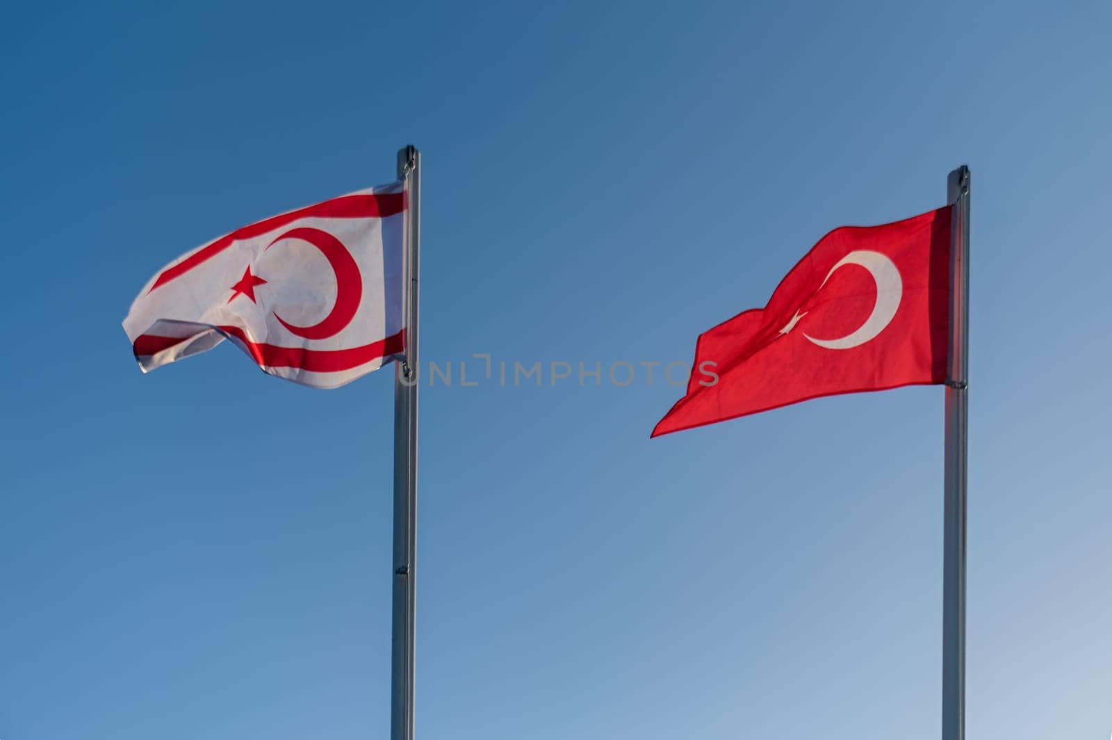 flags of the Turkish Republic of Northern Cyprus and Turkey against the blue sky 1