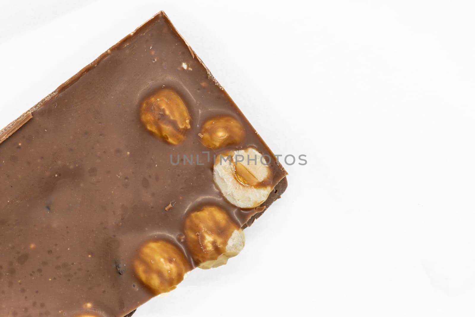 Milk Chocolate Bar with Hazelnuts on White Background by exndiver
