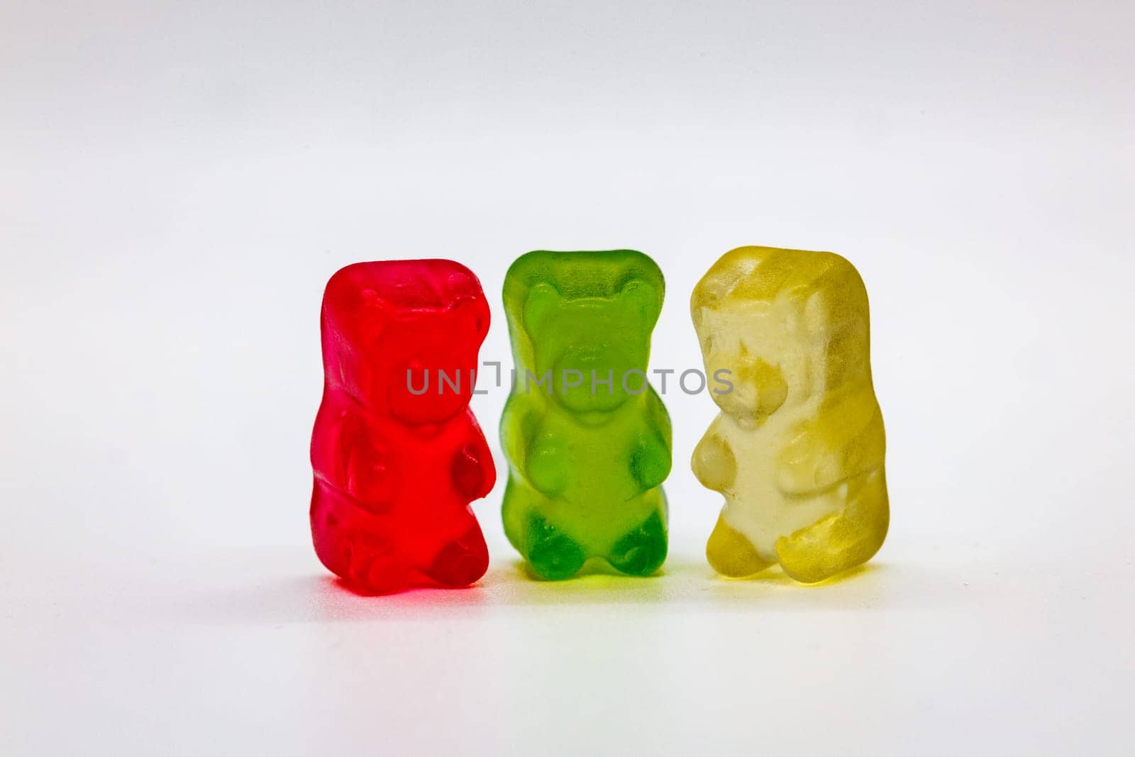 Colorful Gummy Bears in a Row on White Background by exndiver