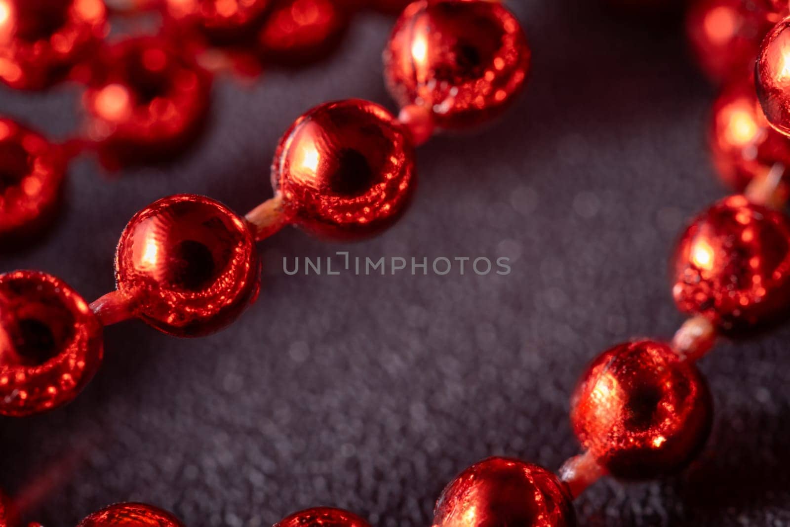 Red and bright Christmas pearls, Christmas tree decorations, garlands, decorations. Close-up macro photography