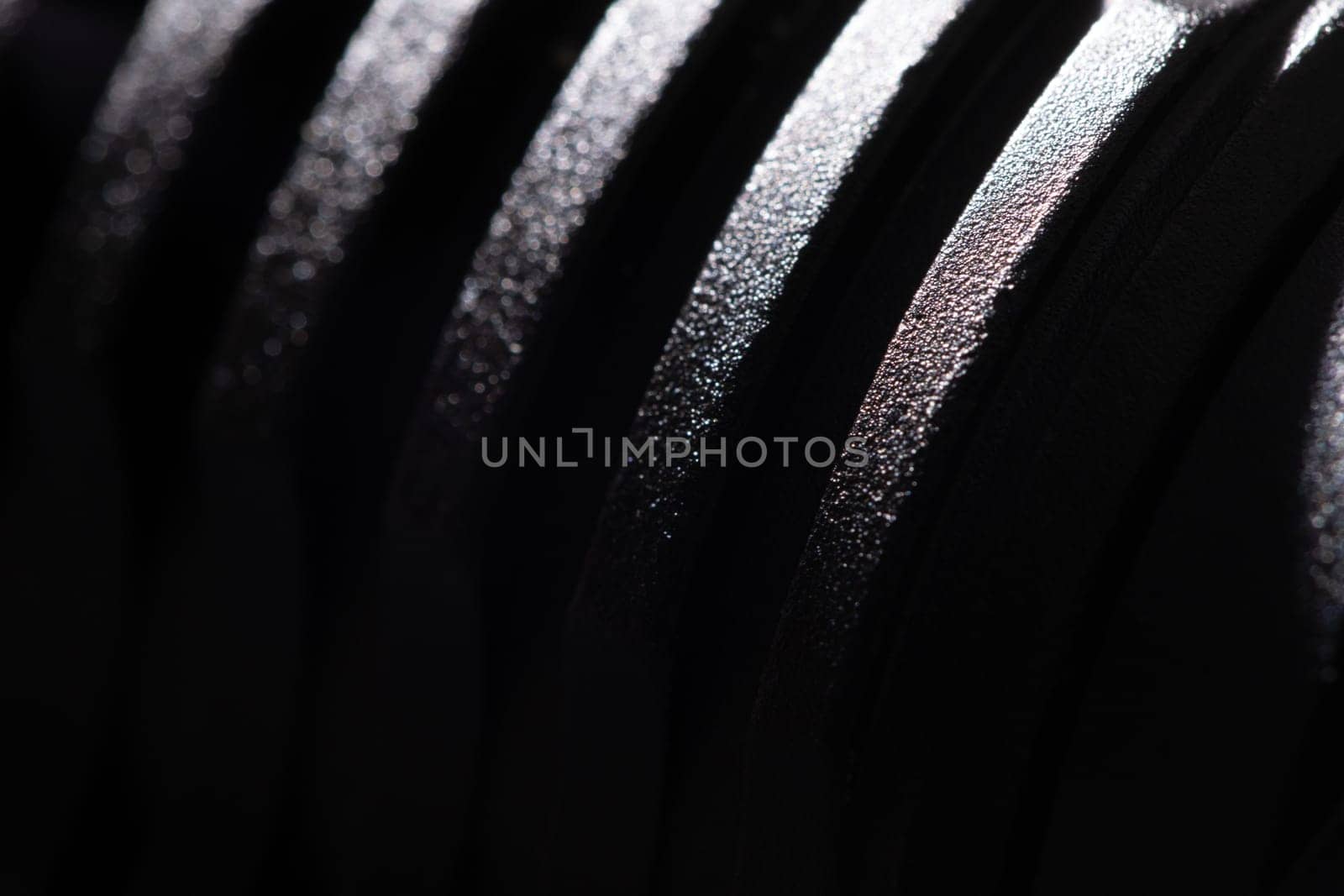 Texture of a black metal part close-up by clusterx