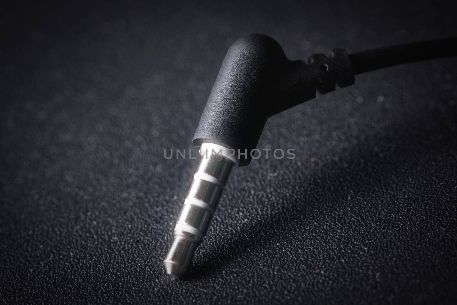 Audio Mini Jack plug on black background by clusterx