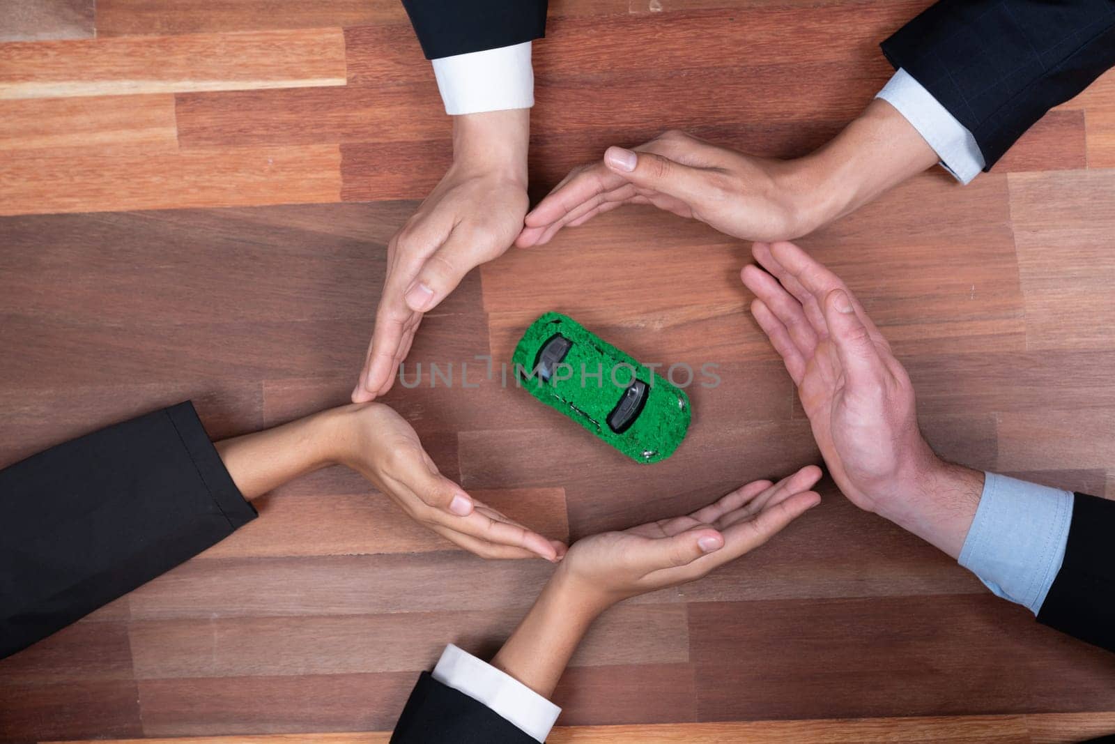 Business people synergy holding EV car model. Quaint by biancoblue