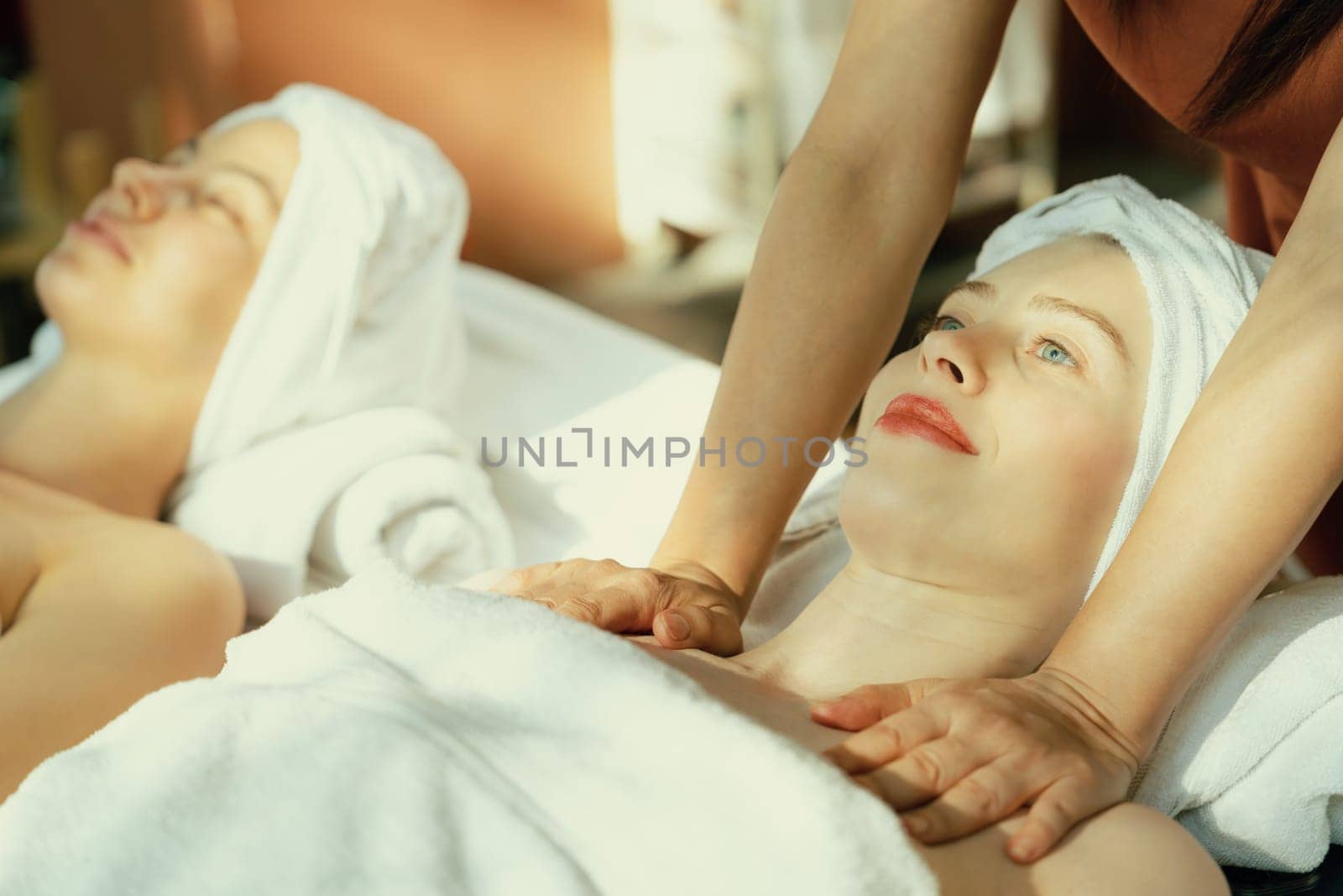 Two beautiful woman having massage. Calming and relaxing concept. Tranquility. by biancoblue