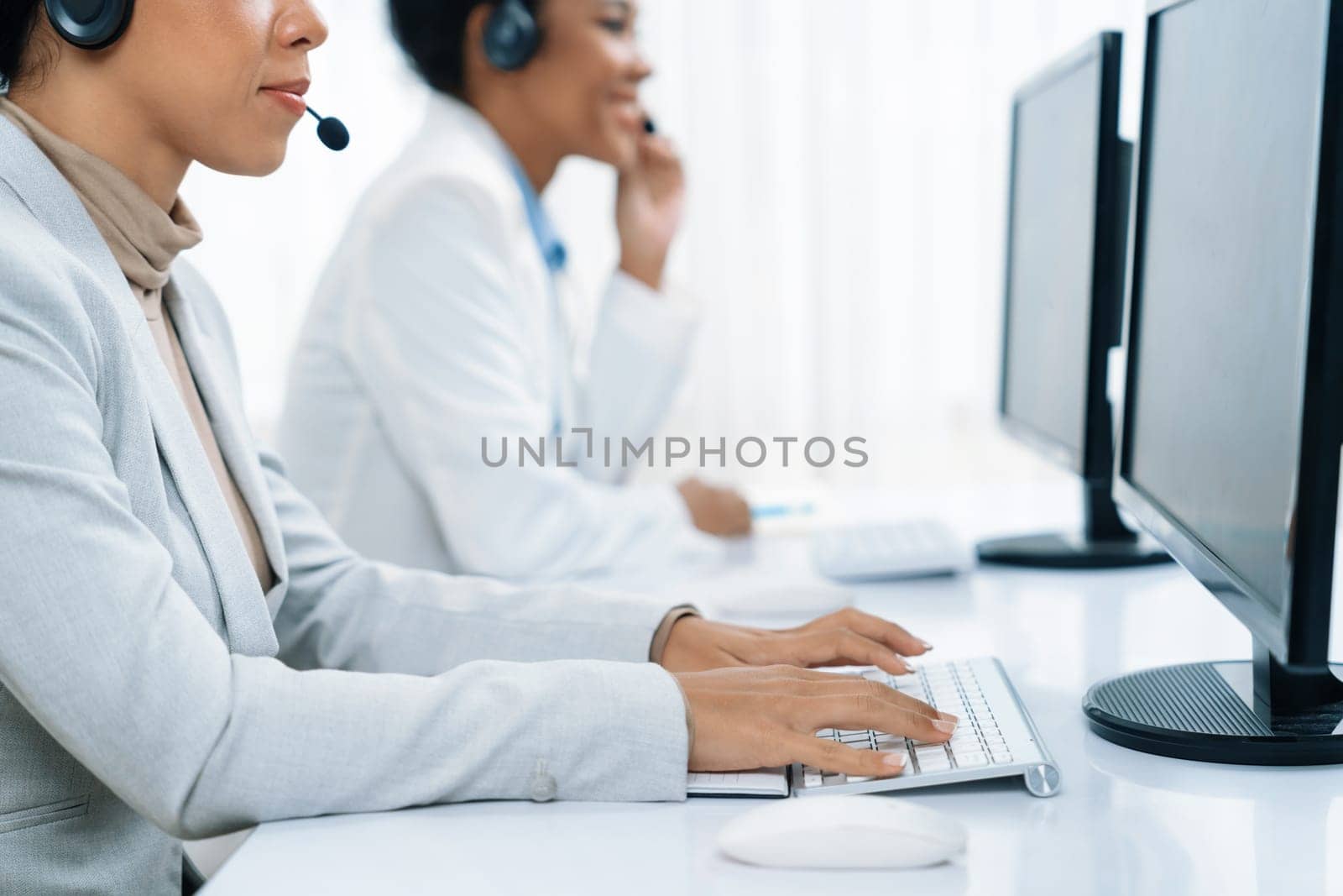 Business people wearing headset working in crucial office by biancoblue