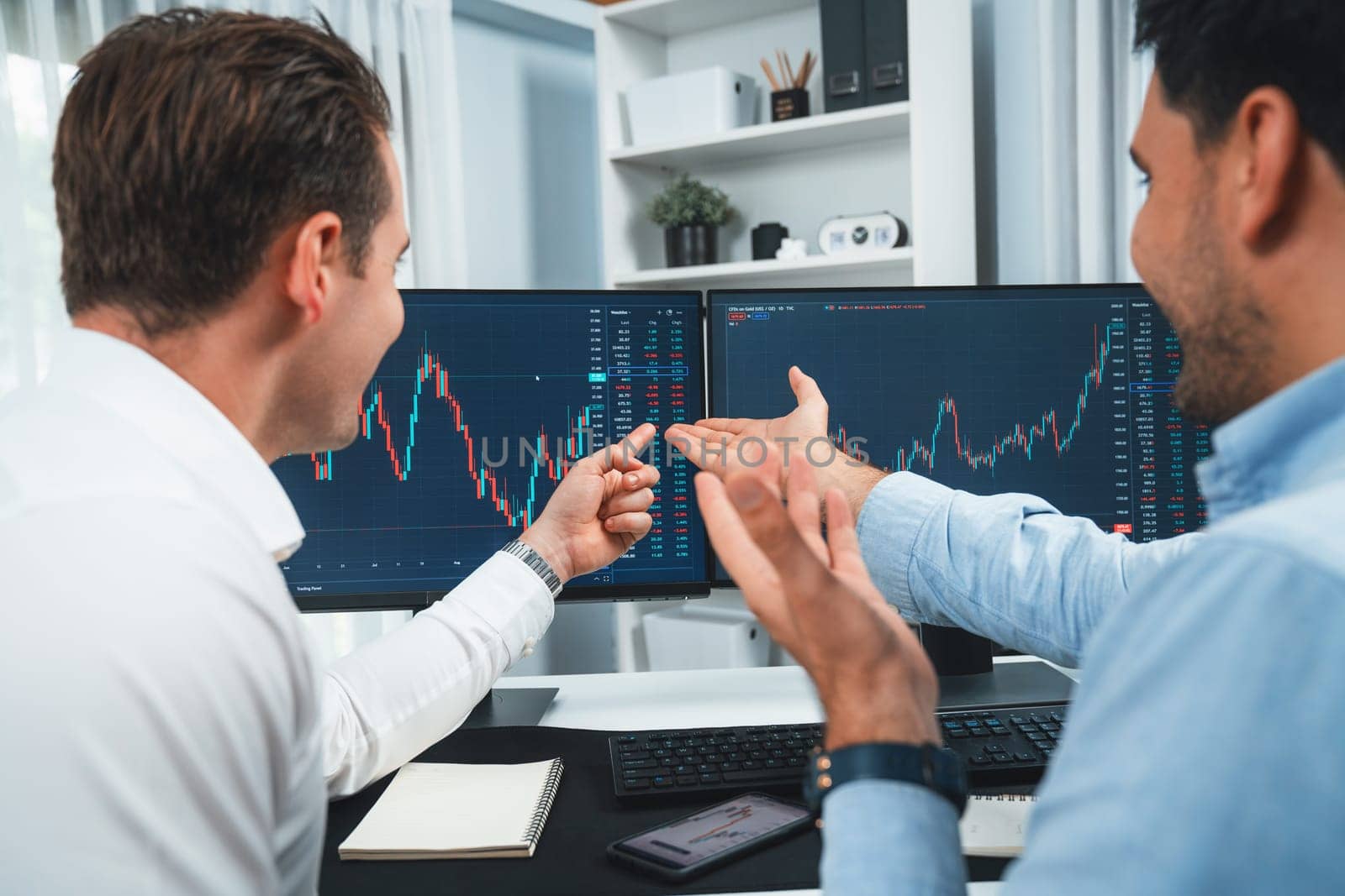 Successful stock exchange traders focusing on high profit chart investment on dynamic database, analyzing on monitor. Concept of discussing financial technology growth at workplace. Sellable.