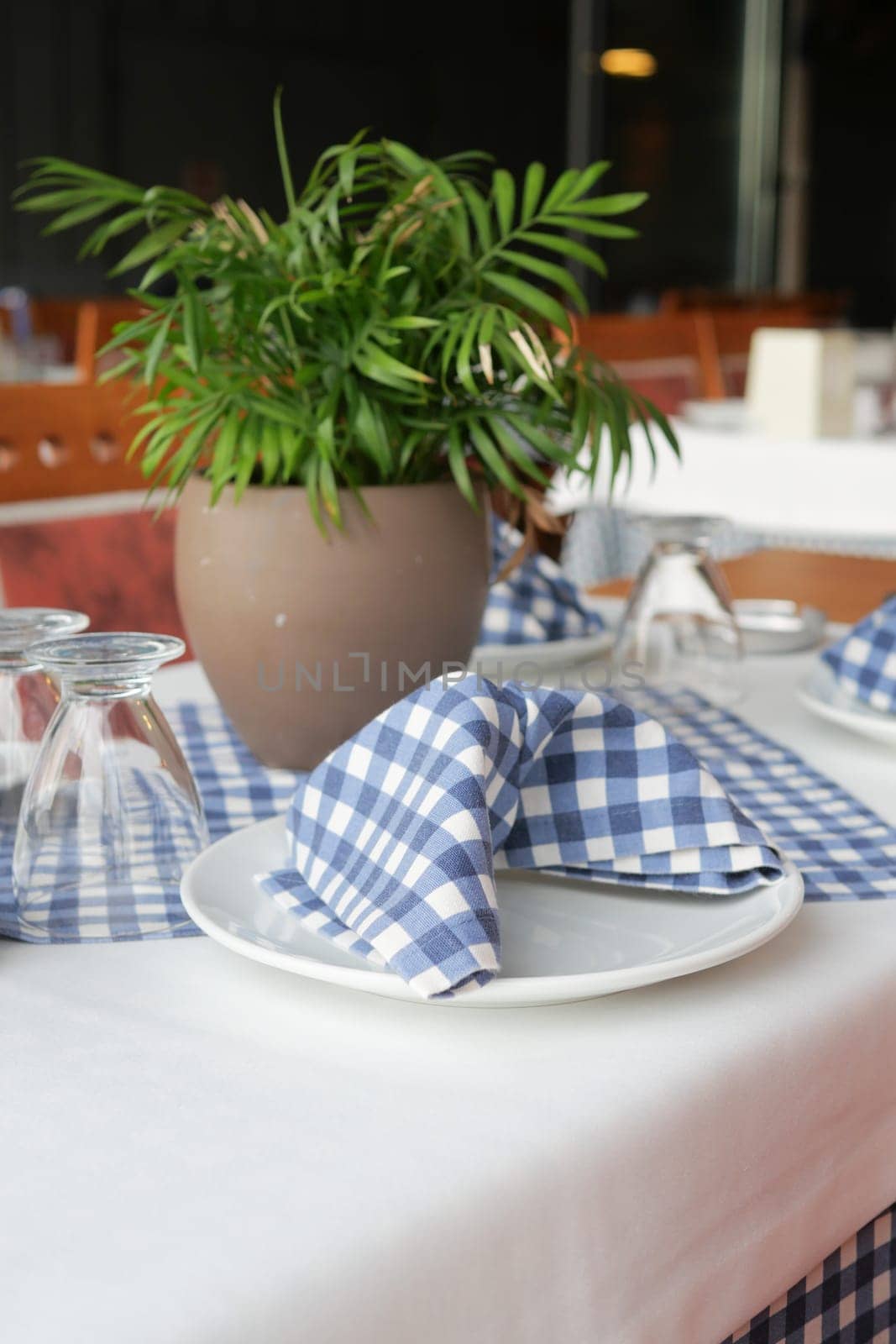 served and decorated round festive table in a restaurant .