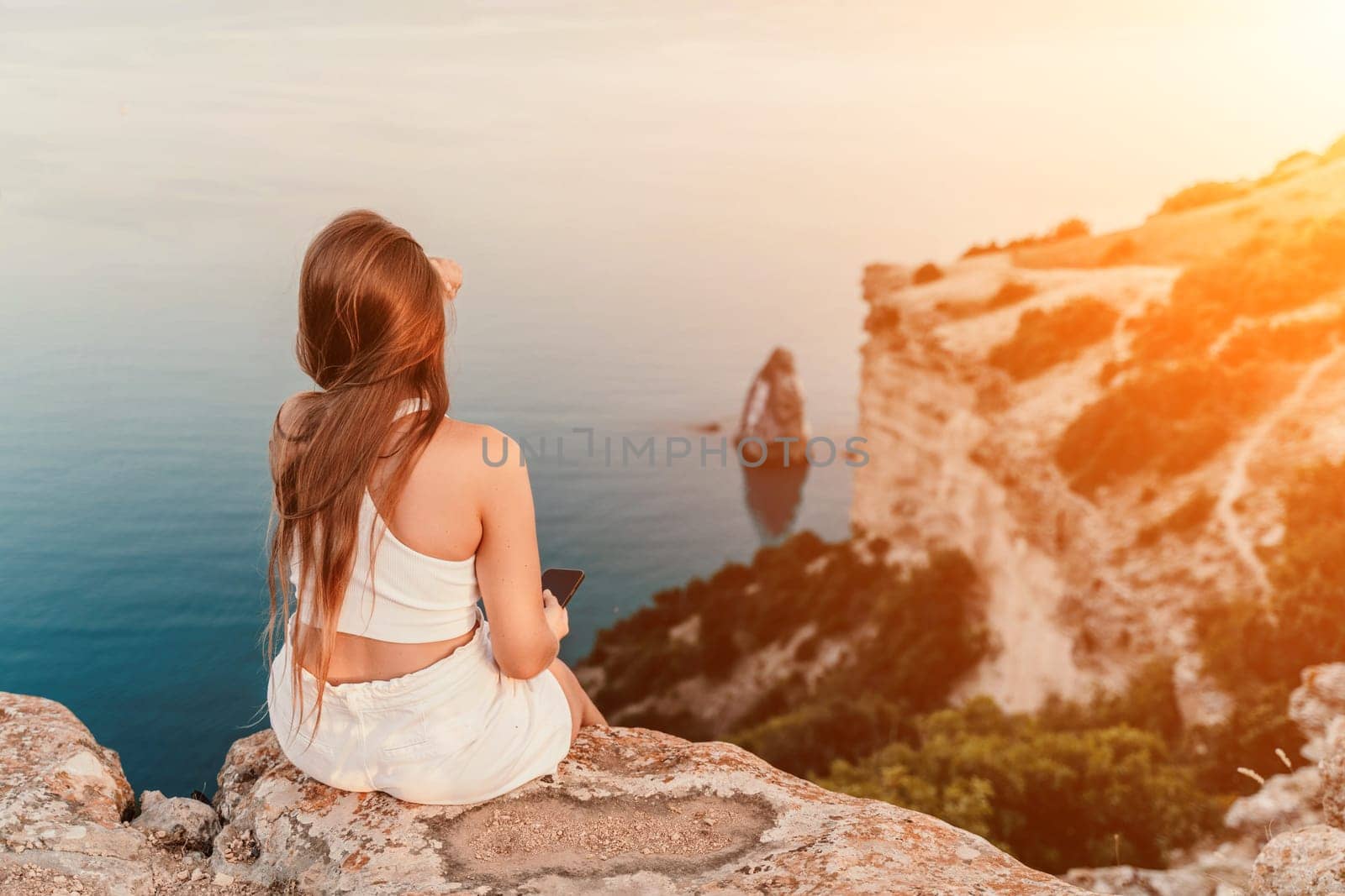 A portrait of a woman in white shorts and T-shirt with long hair, standing against the sea, showcasing her joyful and contented mood. by Matiunina