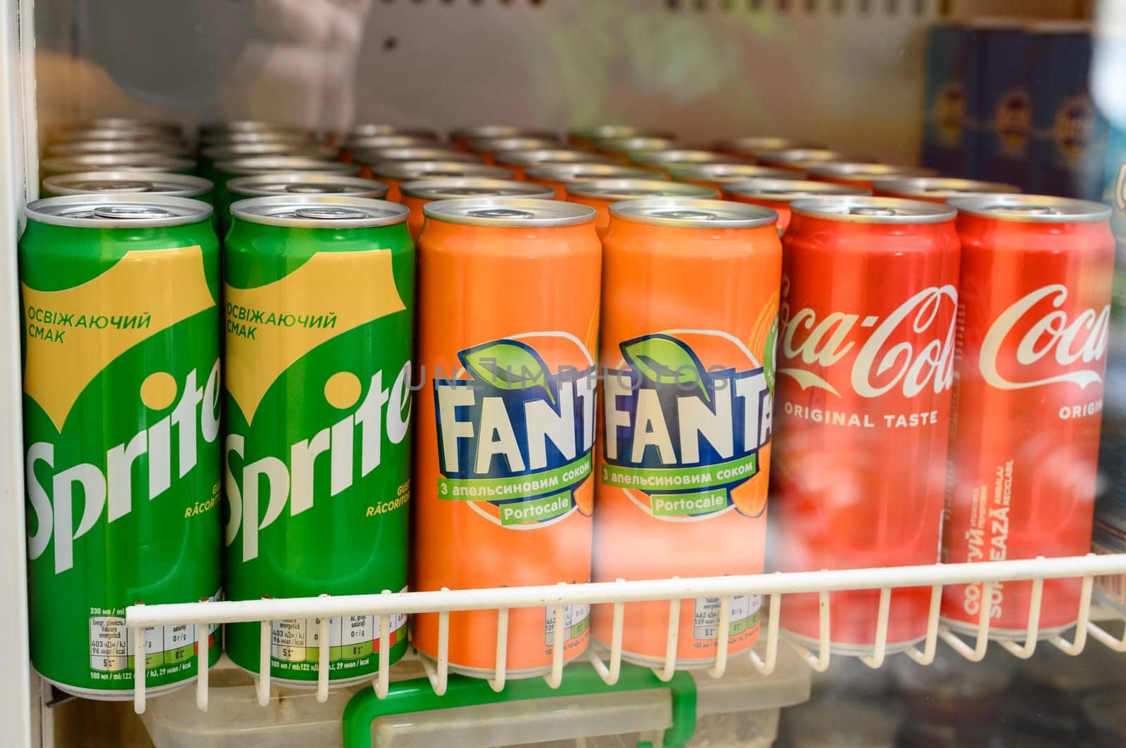 Ivano-Frankivsk, Ukraine March 26, 2023: Sprite, Fanta, Coca Cola drinks on the display of a refrigerator, cooling and carbonated drinks.