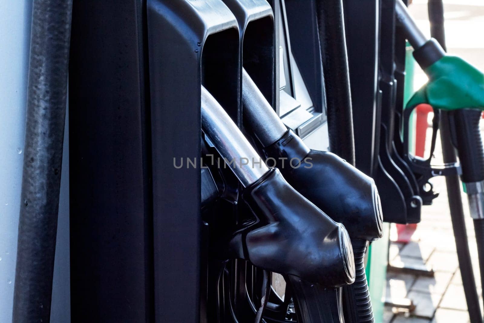 Refueling pistols at a gas station close up, copy space
