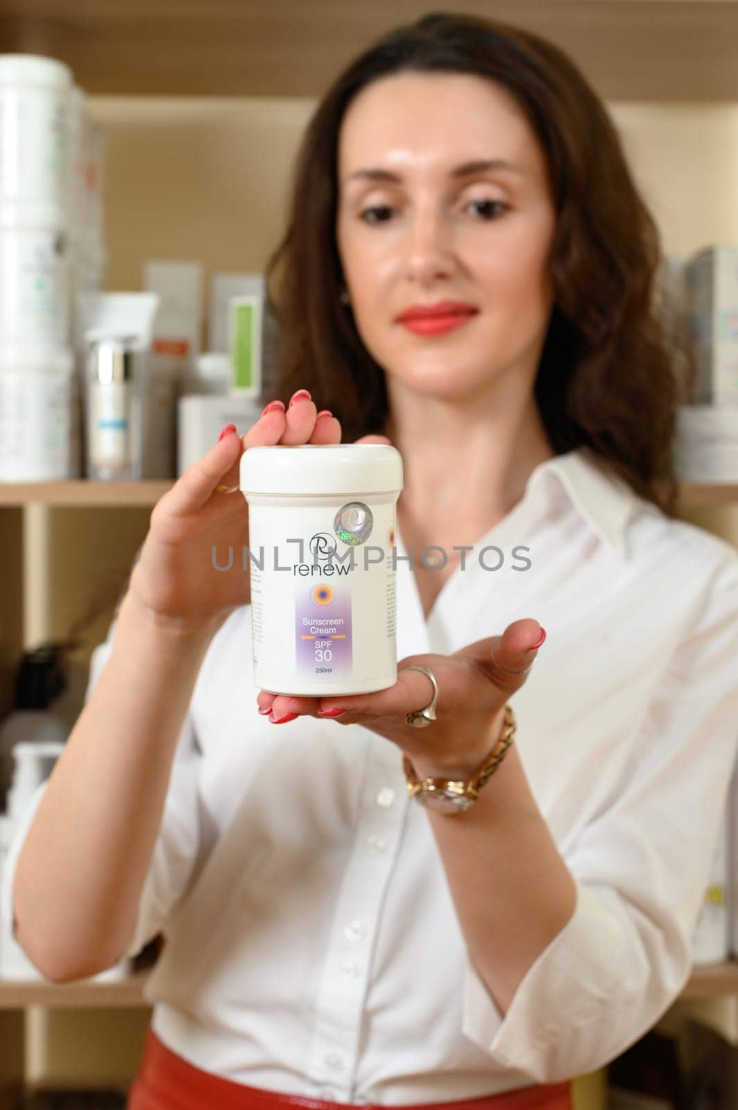 Ivano-Frankivsk, Ukraine May 17, 2023: sunscreen cream in the hands of a beautician by Niko_Cingaryuk