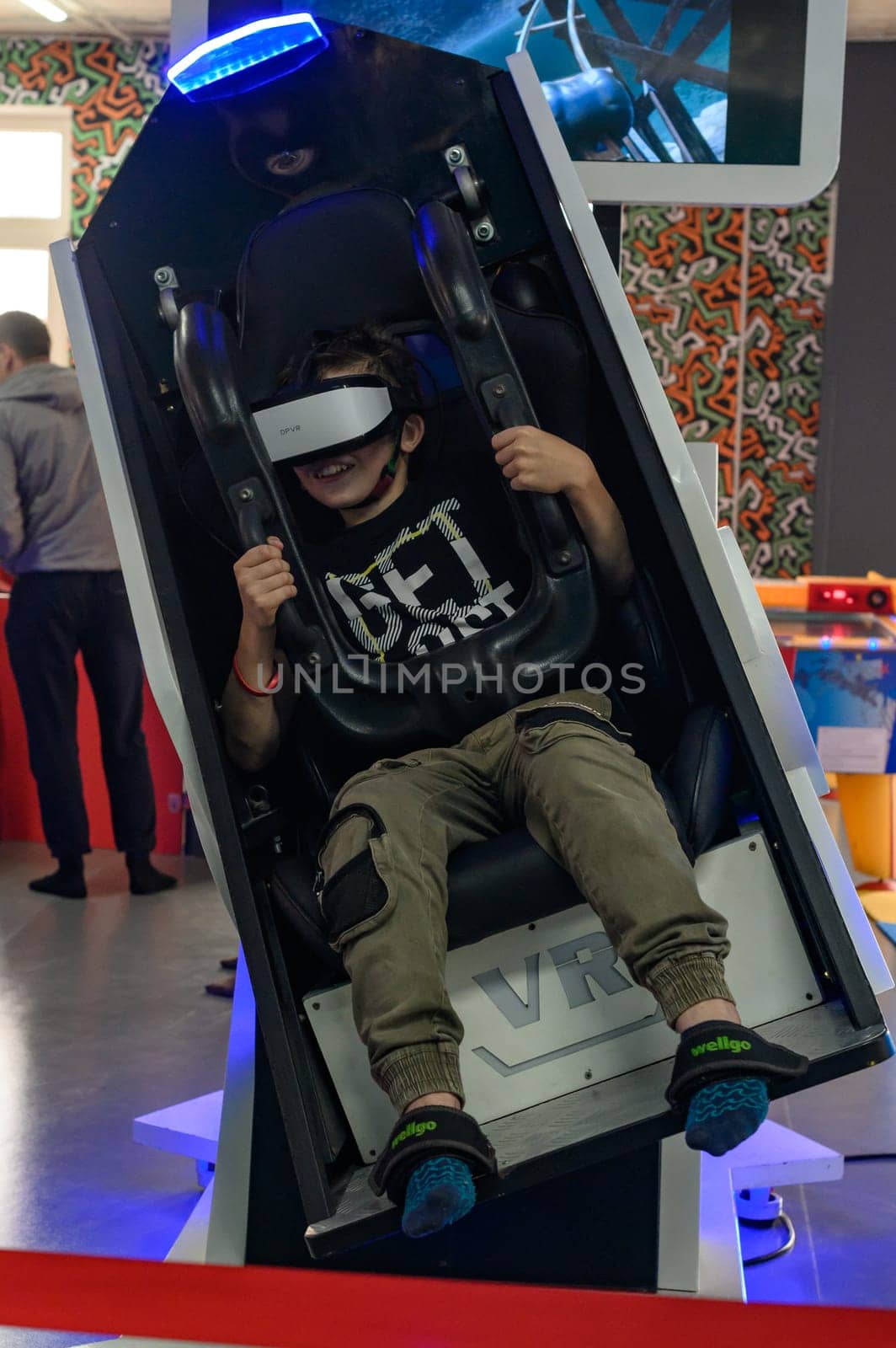 Ivano-Frankivsk, Ukraine June 7, 2023:A guy is sitting on a ride with vr glasses, 5d and adrenaline from virtual reality.