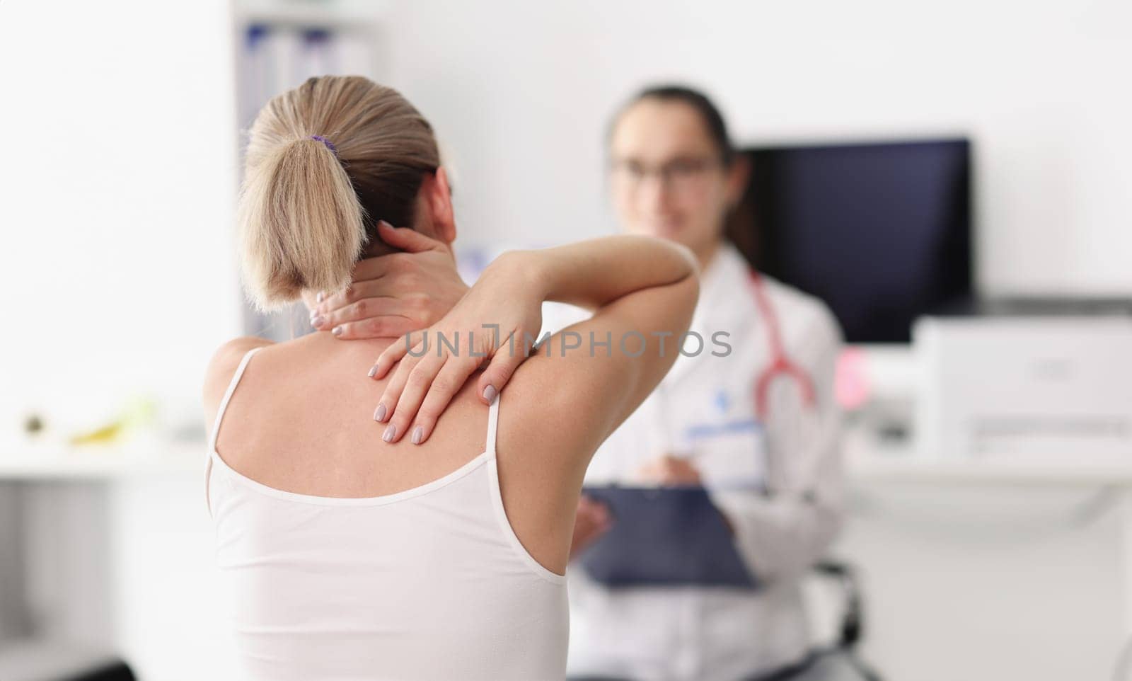 Patient with back pain problems at doctor's appointment. Vertebral hernia examination and treatment concept