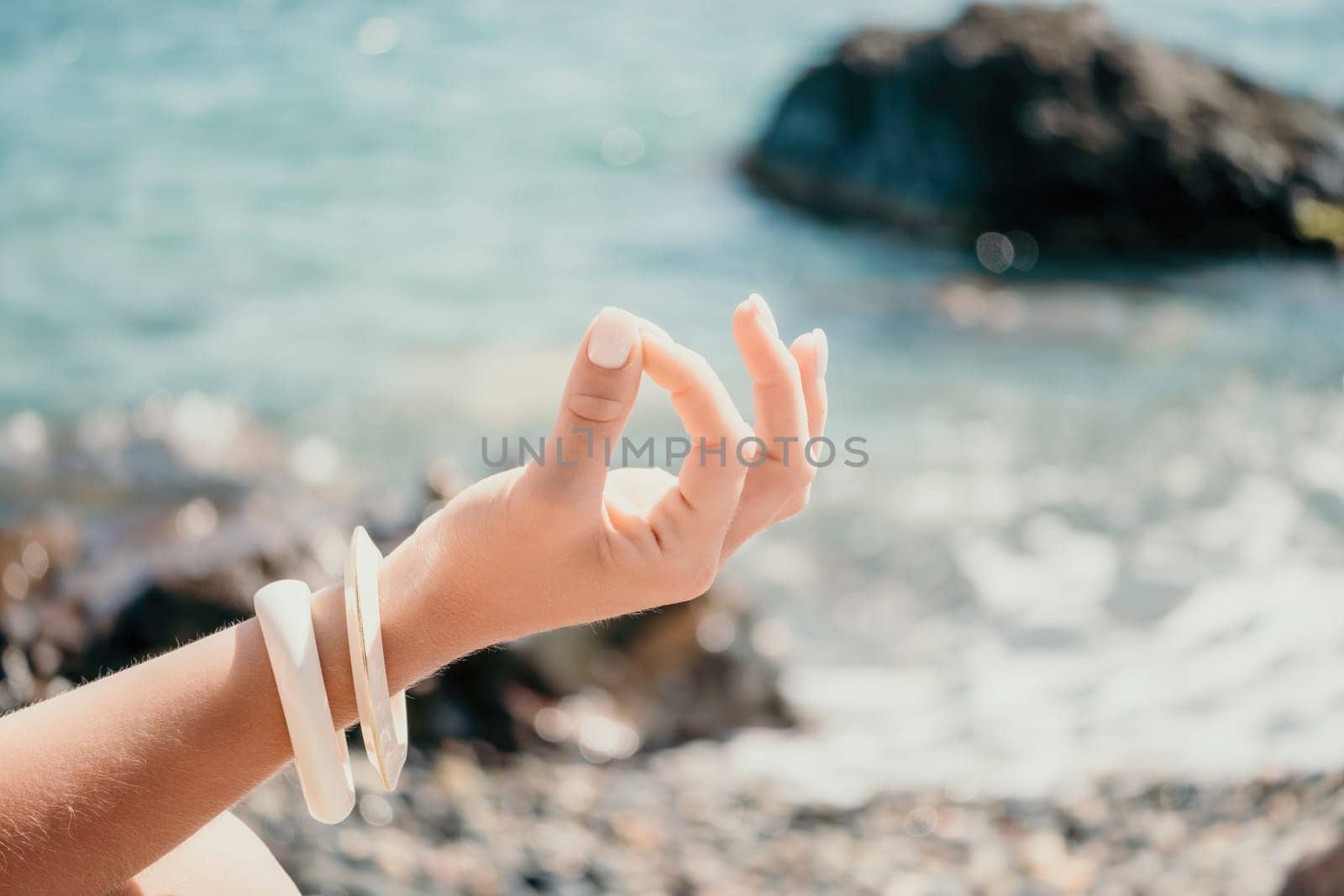 Close up Hand Gesture of Woman Doing an Outdoor Lotus Yoga Position. Close up. Blurred background