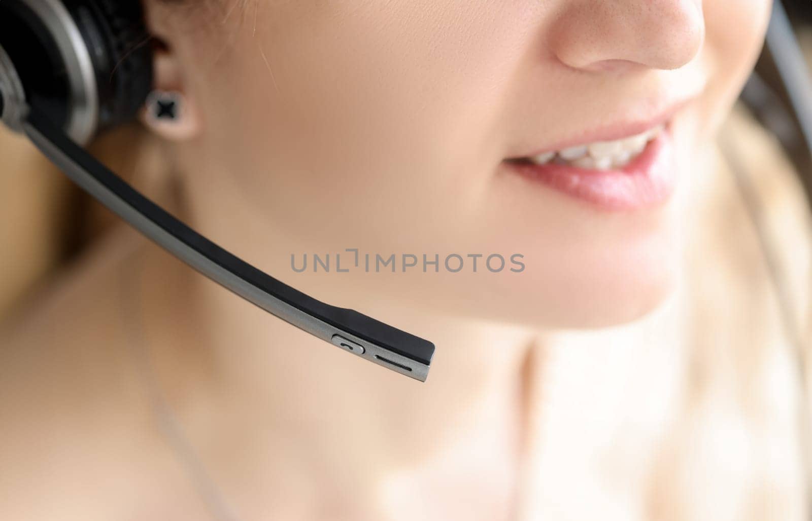 Closeup of black head set on woman head. Psychological assistance by phone concept