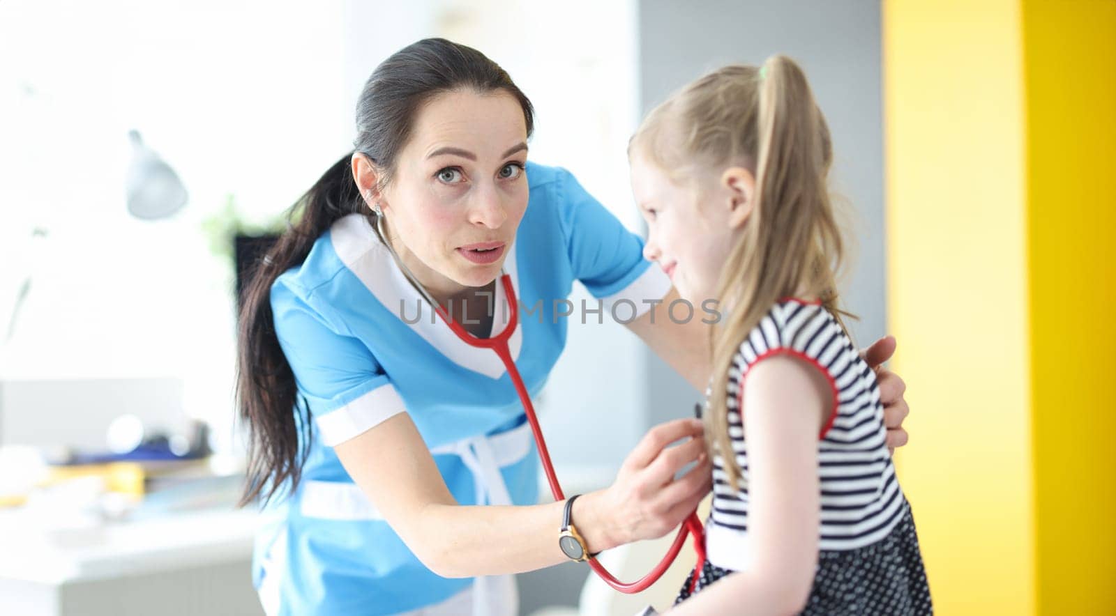 Doctor pediatrician forgot to put stethoscope in her ears. First day of work as doctor concept