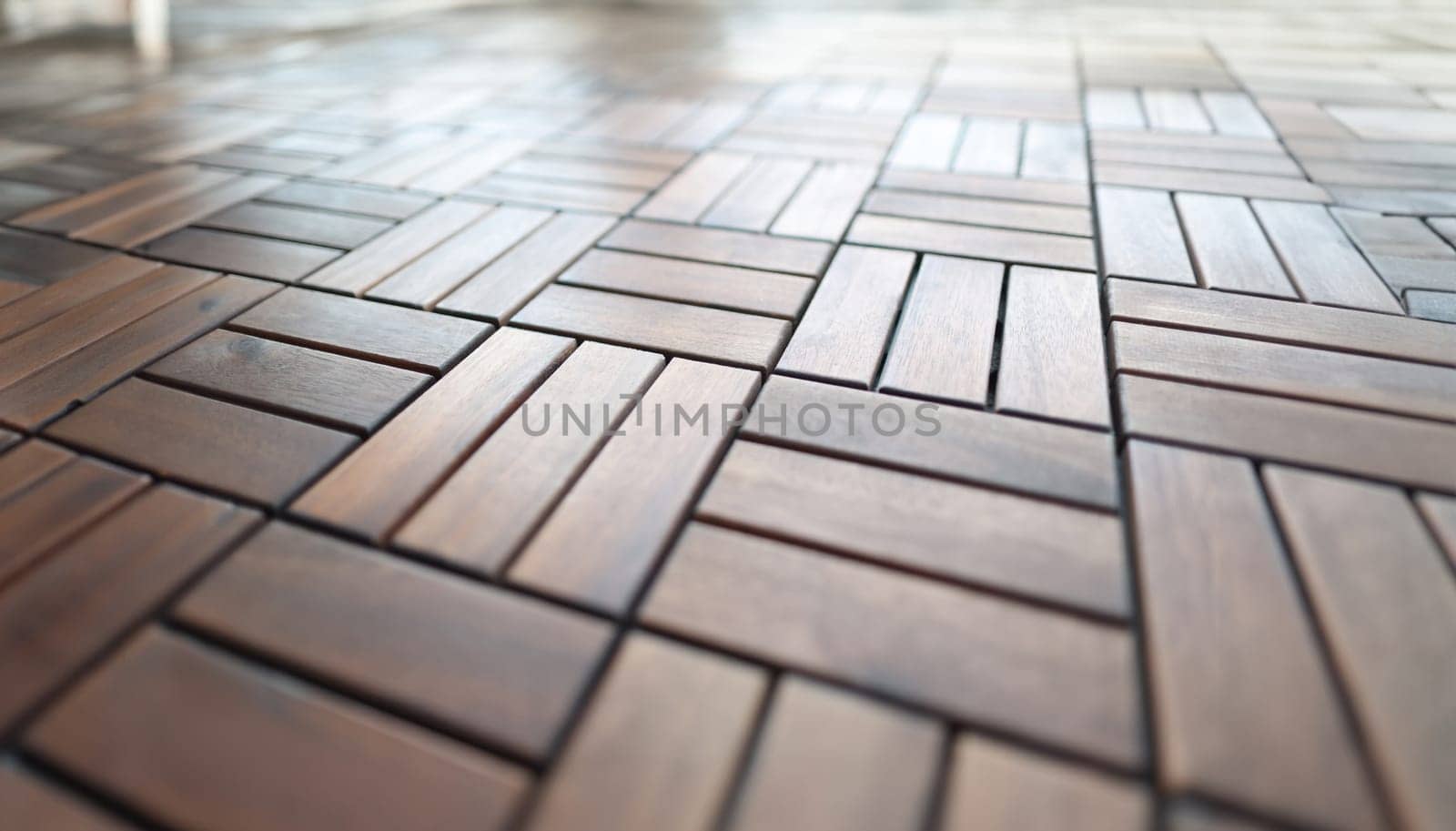 Wooden brown tiles lying on floor closeup by kuprevich