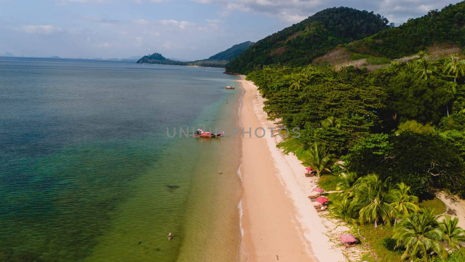 calm beach with crystal clear water on the blue sky at Koh Libong, Trang province, Thailand, Andaman Sea.