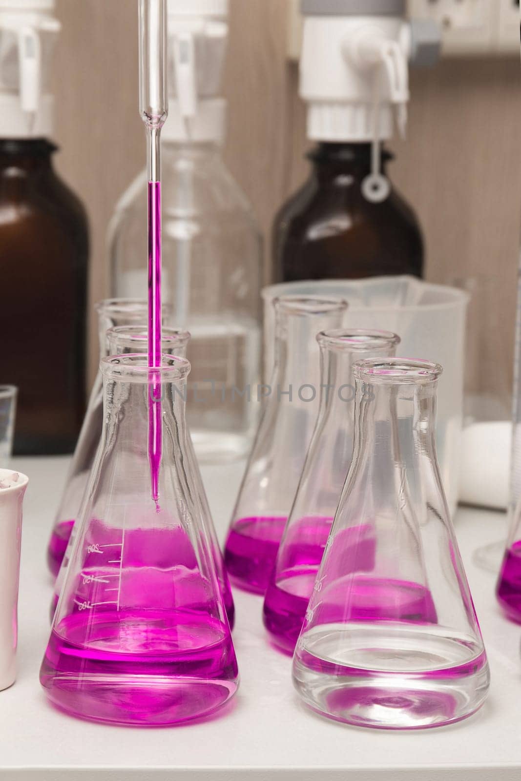 Flasks with liquid colored pink. Chemical analysis, organic test of water in the laboratory by ElenaNEL