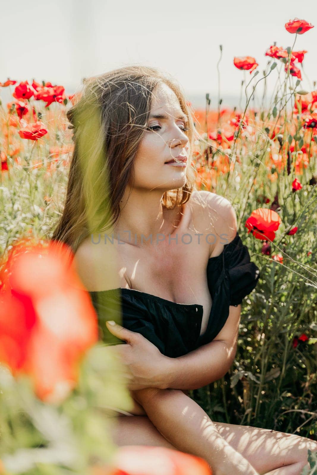 Woman poppies field. portrait happy woman with long hair in a poppy field and enjoying the beauty of nature in a warm summer day. by Matiunina