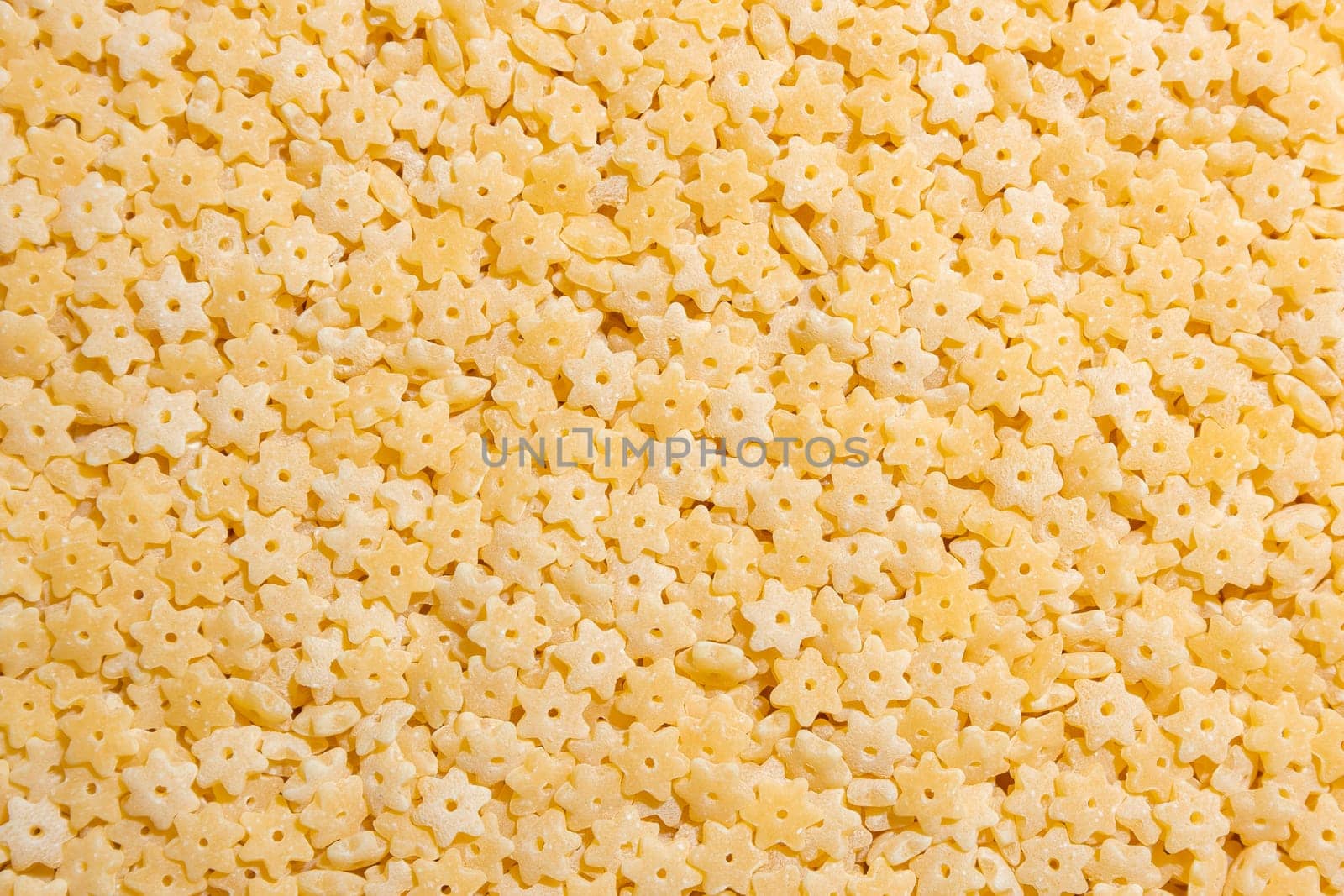Uncooked Stelline Pasta: A Culinary Canvas of Stelline Macaroni, Creating a Lively and Textured Background for Gourmet Cooking. Dry Pasta. Raw Macaroni - Top View, Flat Lay