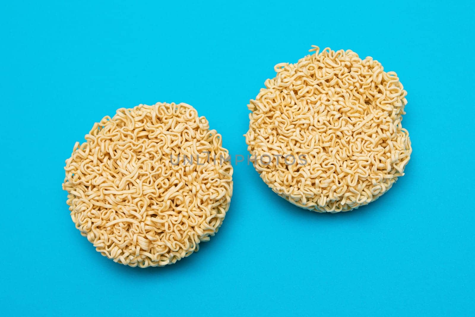 Uncooked Instant Noodles on Blue Background by InfinitumProdux