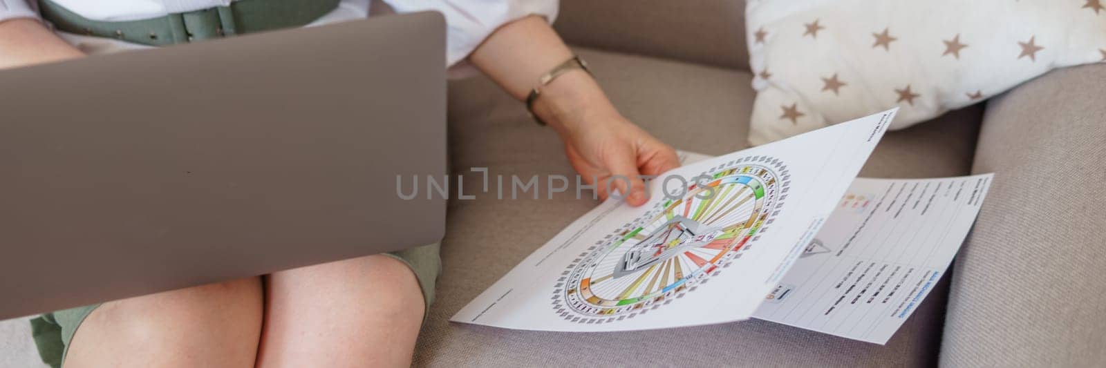 Tver, Russia-august 7, 2022. A woman with a laptop is studying human design. The concept of studying esoteric sciences. Studying rave postcards from human design.