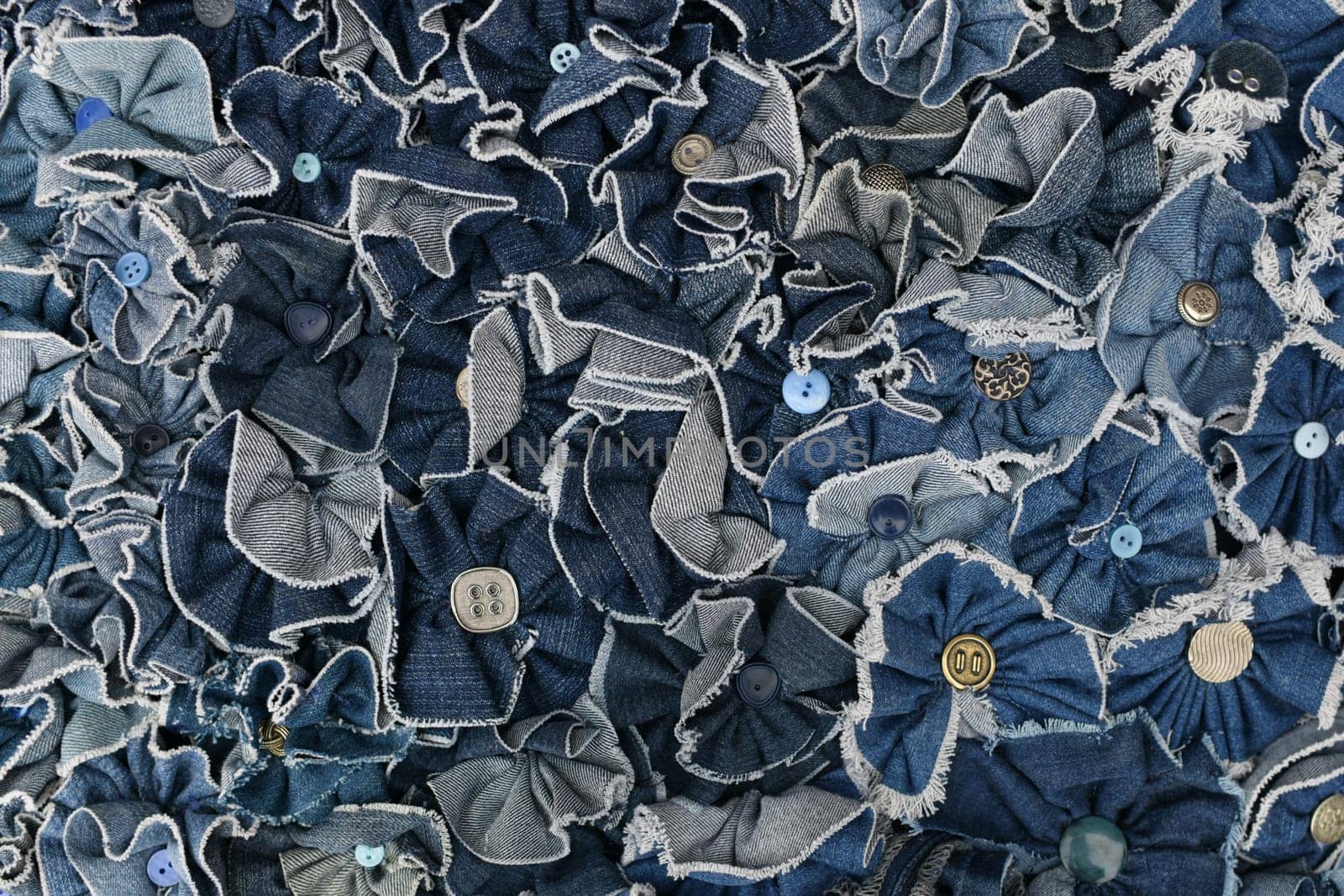 Denim blue jeans pieces with buttons Background texture