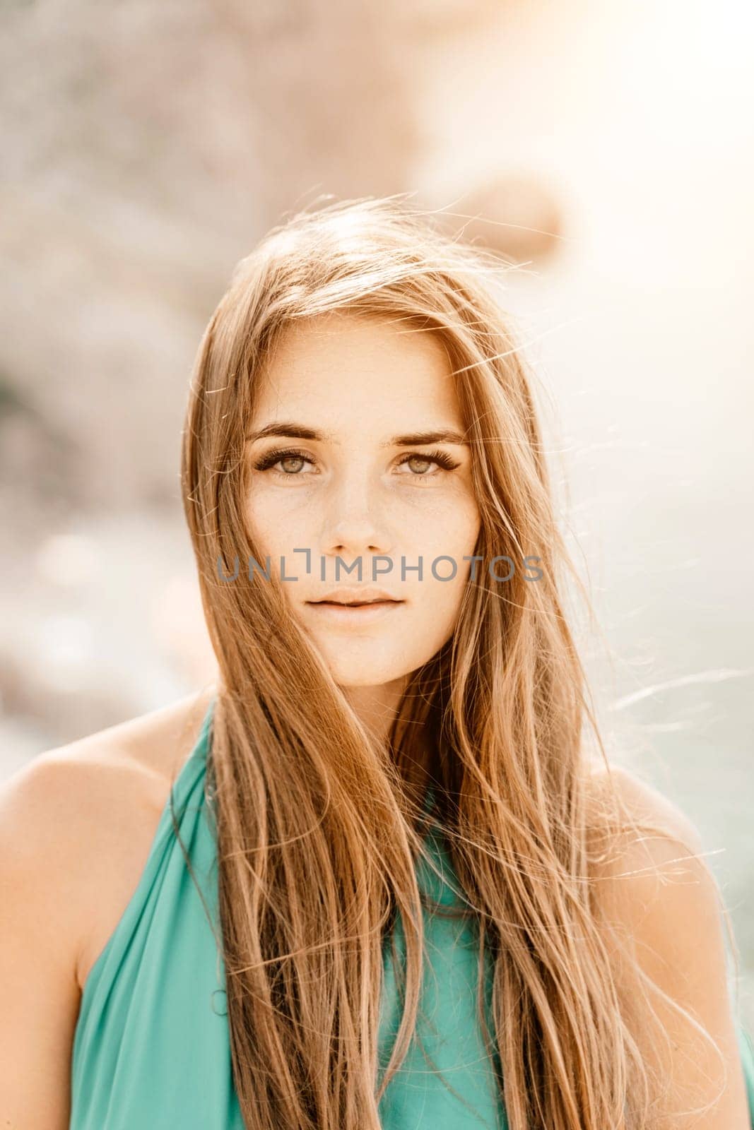 Woman sea green dress. Portrait of a happy woman with long hair in a long mint dress posing on a beach with calm sea bokeh lights on sunny day. Girl on the nature on blue sky background. by Matiunina