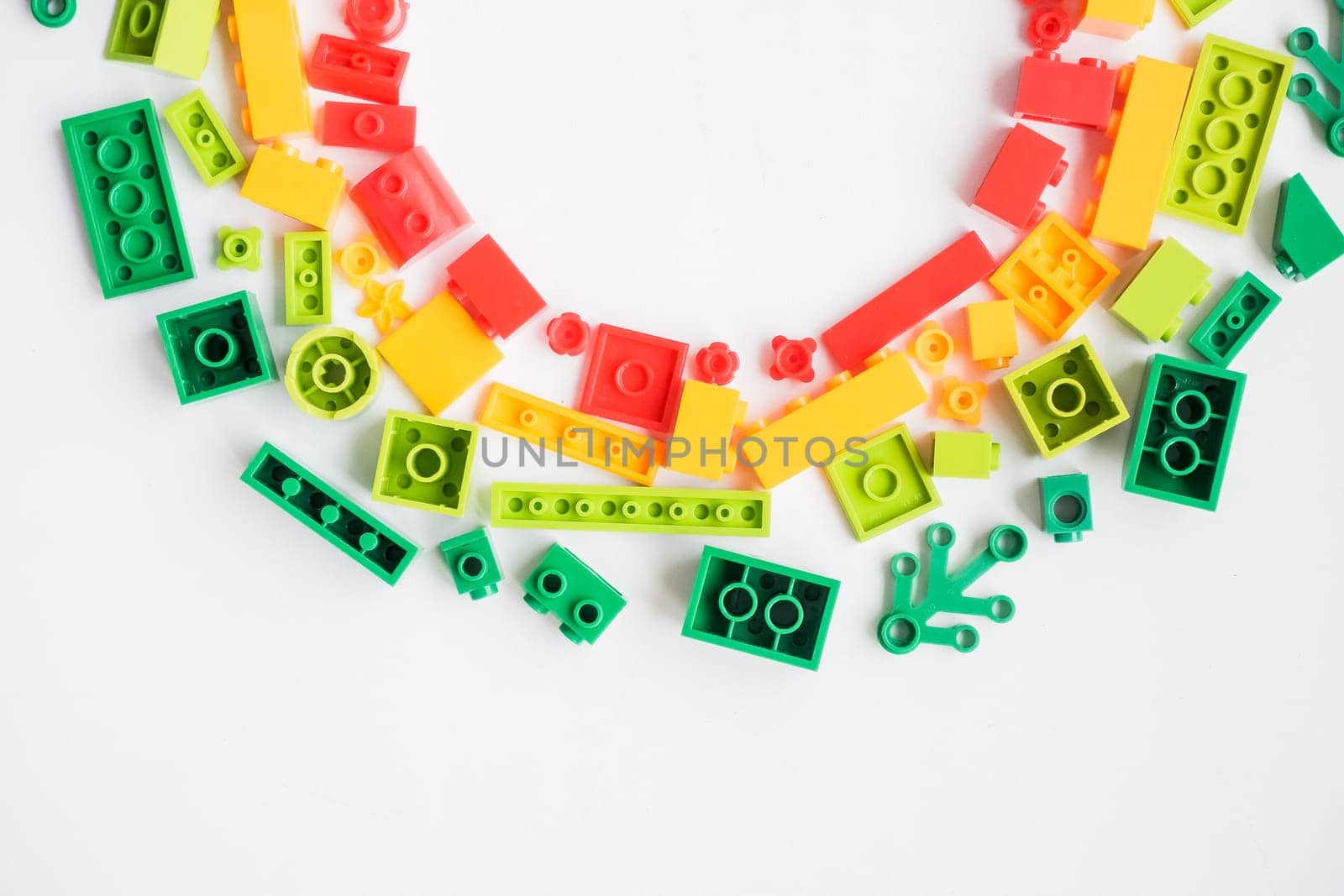 Plastic building blocks pattern on white background, Colorful toy bricks for kid, Top view.Educational and creative toys and games for young children by YuliaYaspe1979