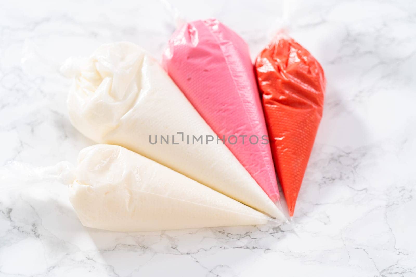 Homemade royal icing for decorating heart-shaped sugar cookies by arinahabich
