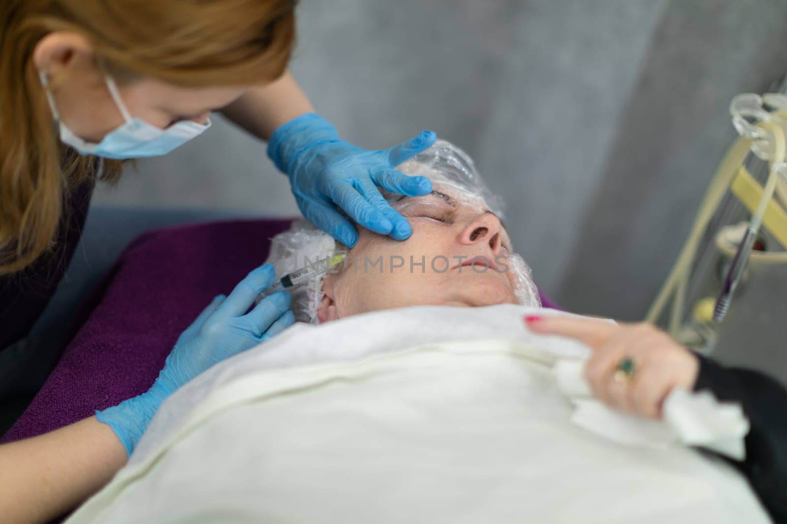 Painful needle mesotherapy treatments performed in a beauty salon. by fotodrobik