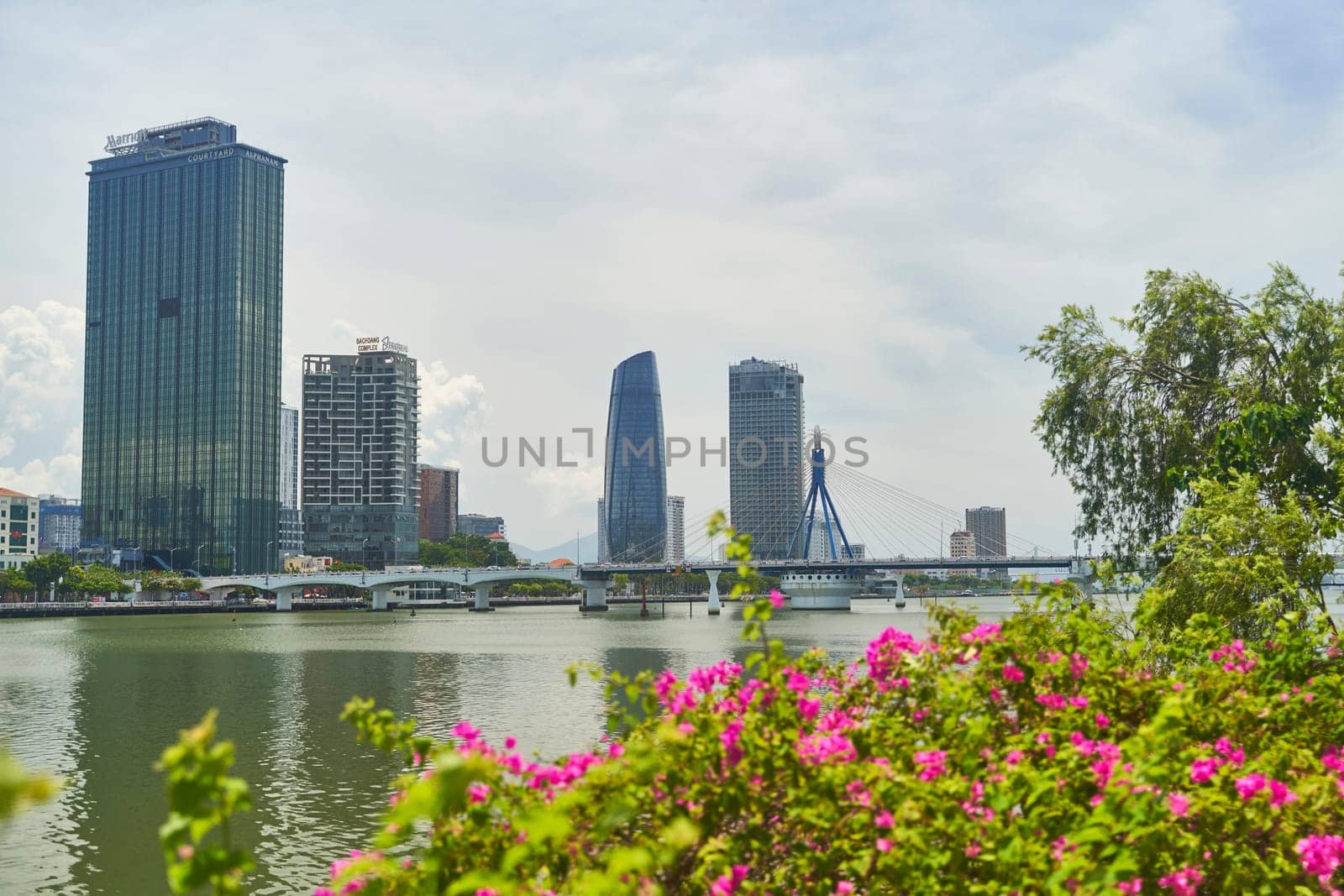 Danang, Vietnam - 06.27.2023: View of skyscrapers across the Han River in Da Nang city, Vietnam. High quality photo