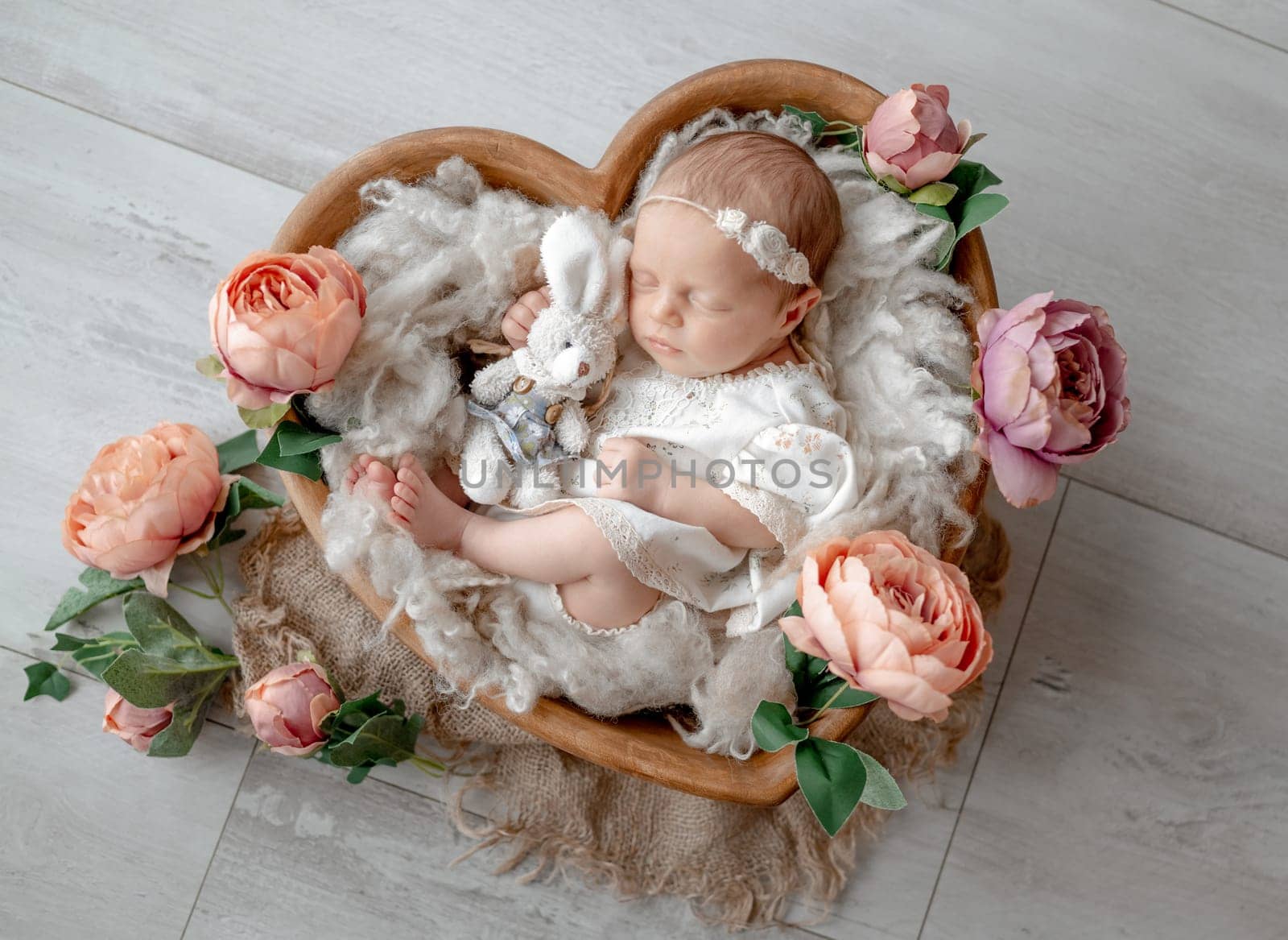 Baby Girl In Dress Sleeps In Heart-Shaped Wooden Bowl Among Flowers by tan4ikk1