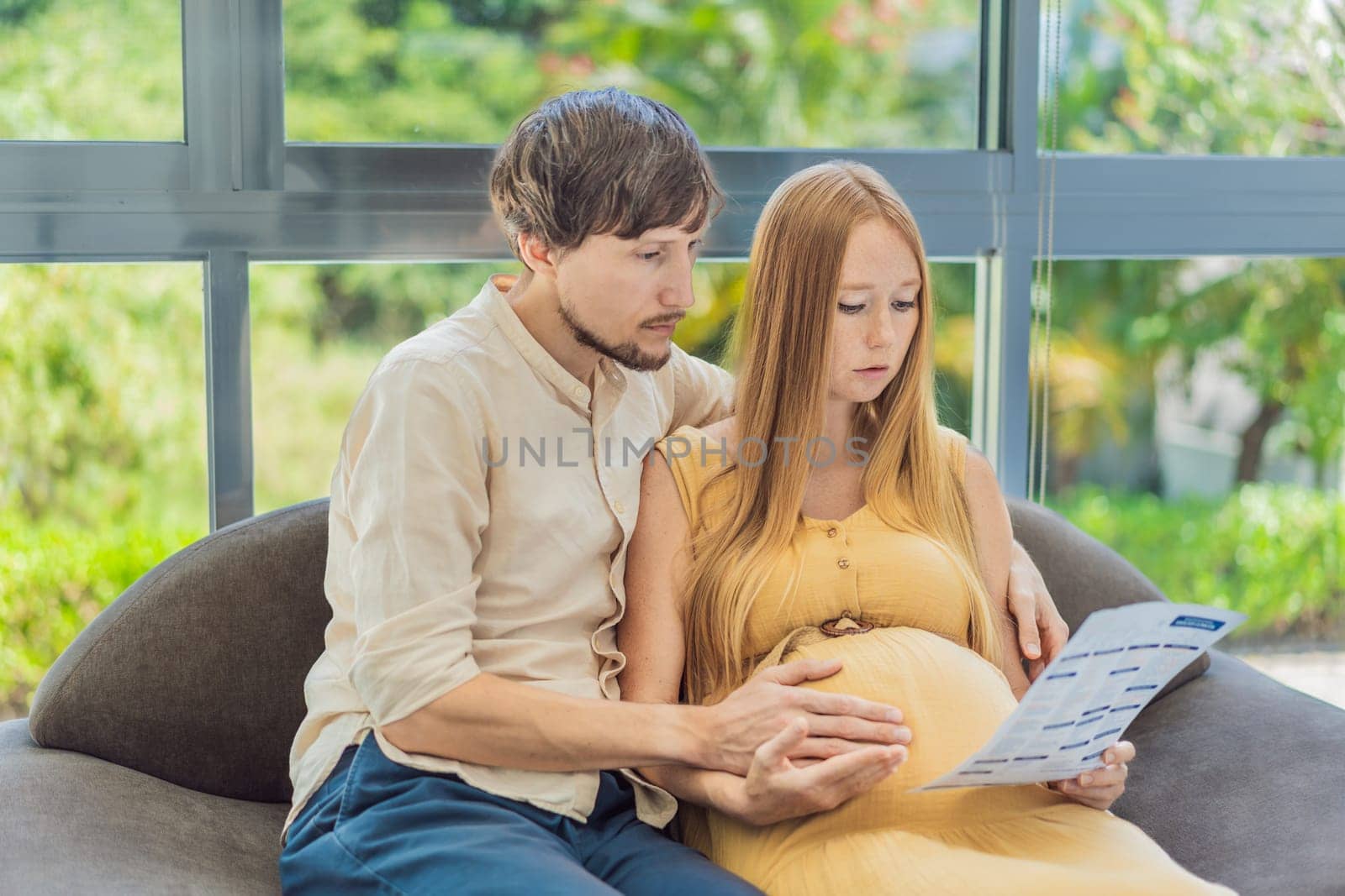Expectant couple reviews blood test results, navigating pregnancy together with concern and anticipation.