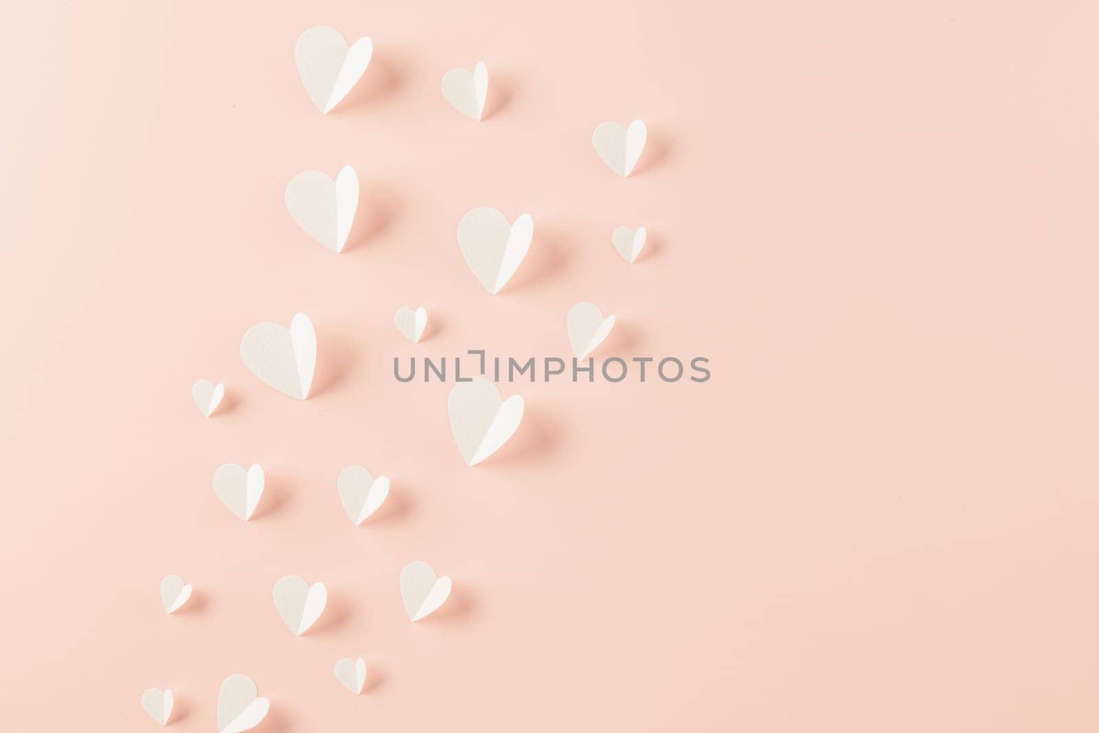 Happy Valentines Day background. Top view flat lay of paper elements cutting white hearts shape flying on pink background with copy space, Happy Mother's Day, Banner template design of holiday