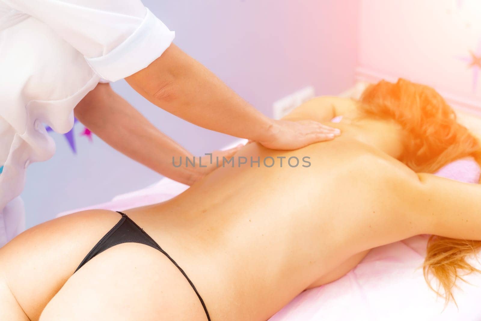 Facial massage. A woman is given a massage in a beauty salon. Close-up. by Matiunina
