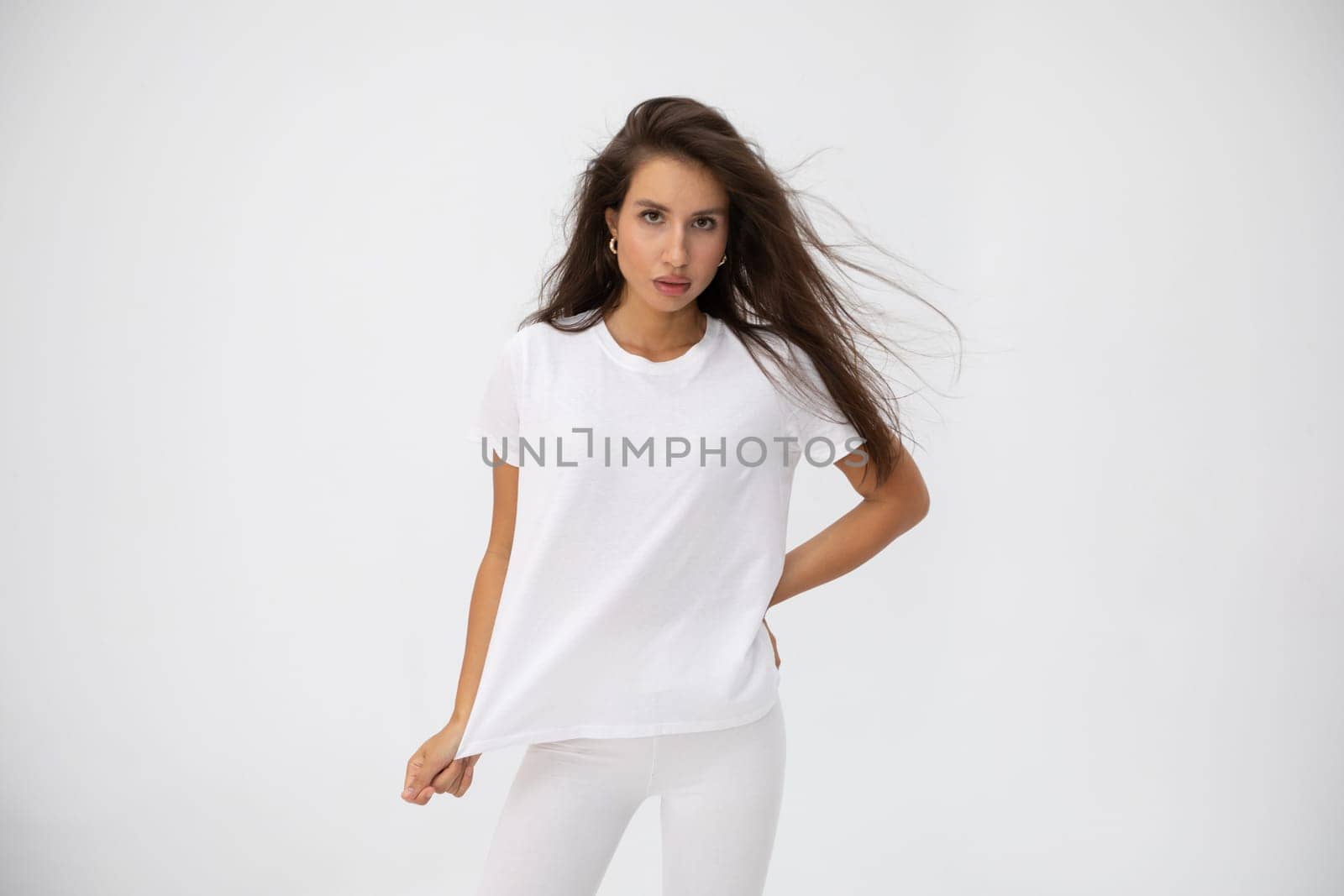 Beautiful brunette girl in a white T-shirt. High quality photo