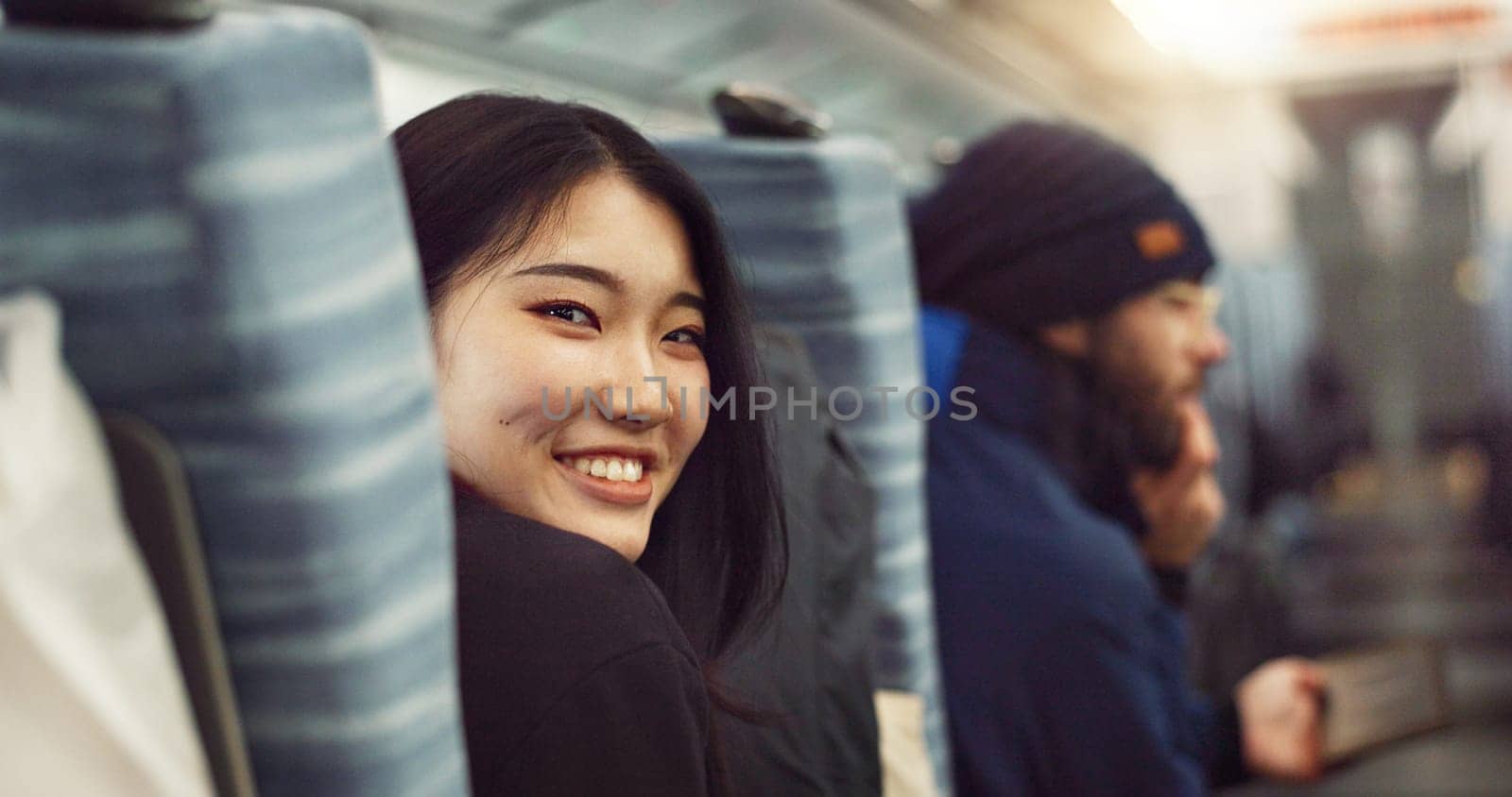 Smile, face and young Asian woman on a train for public transportation to work in the city. Happy, portrait and female person with positive, confident and good attitude for commuting to office. by YuriArcurs