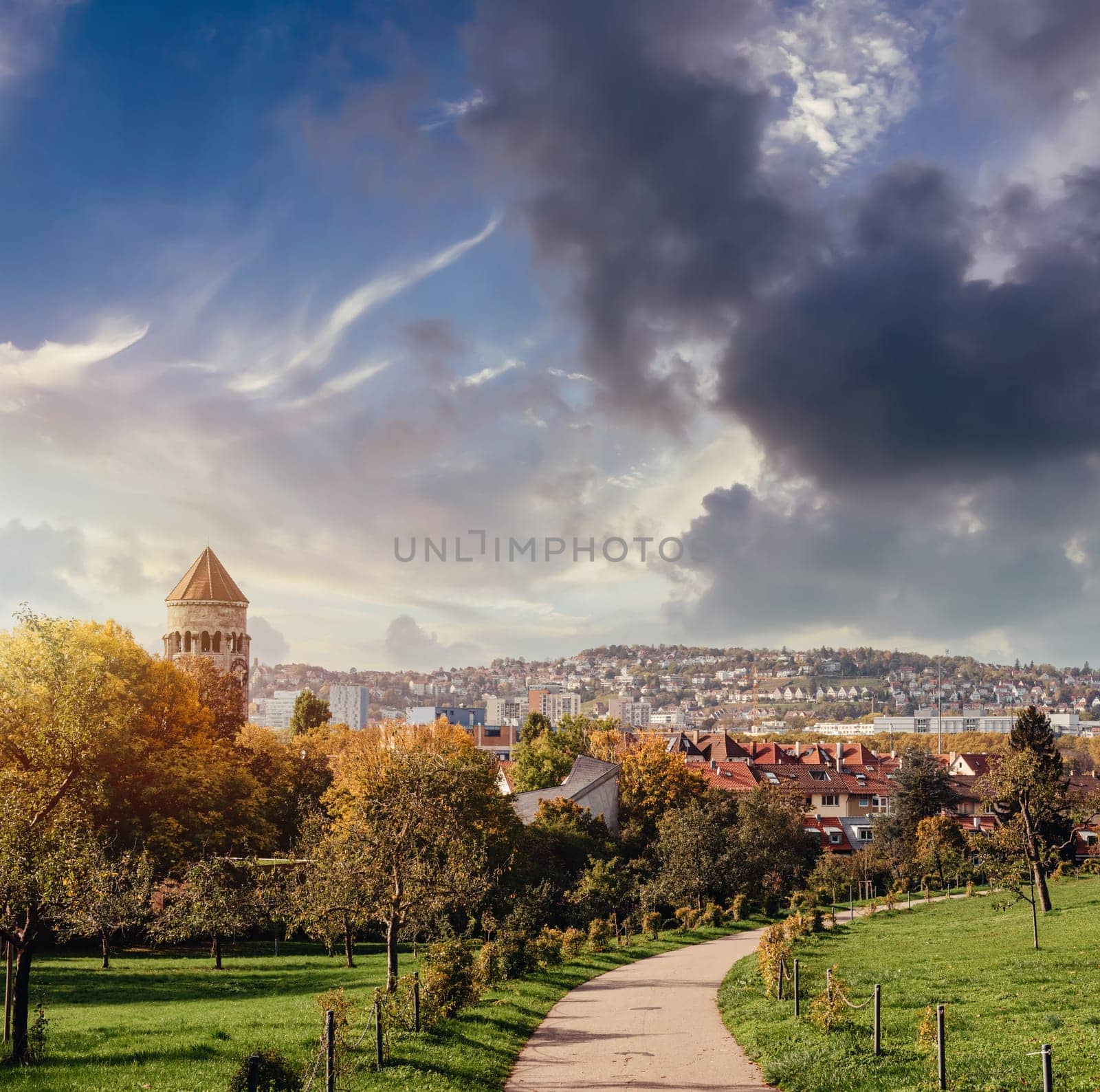 Germany, Stuttgart panorama view. Beautiful houses in autumn, Sky and nature landscape. Vineyards in Stuttgart - colorful wine growing region in the south of Germany with view over Neckar Valley. Germany, Stuttgart city panorama view above vineyards, industry, houses, streets, stadium and highway at sunset in warm orange light by Andrii_Ko