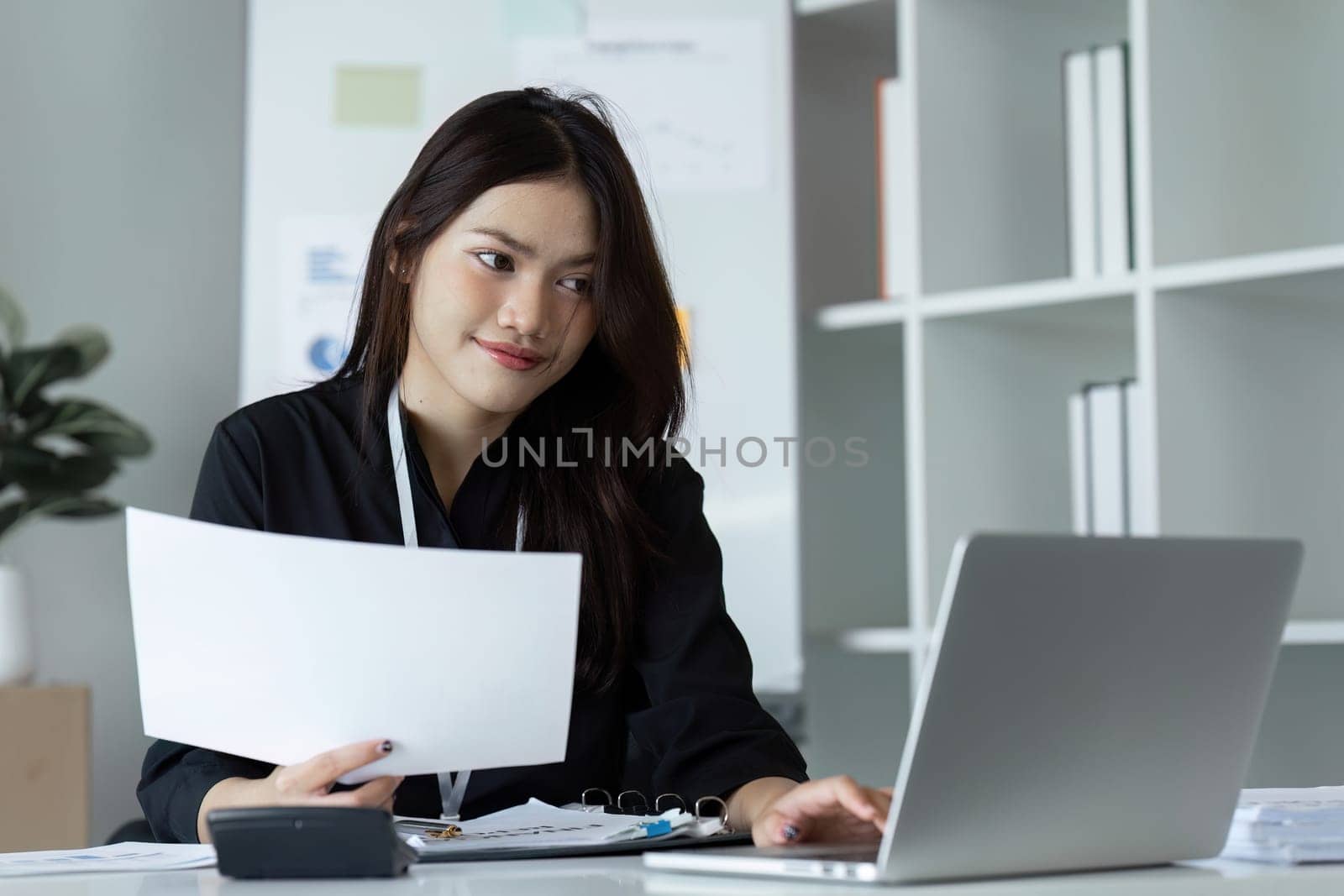 businesswoman working about project with laptop computer and papers working at office. copy space.