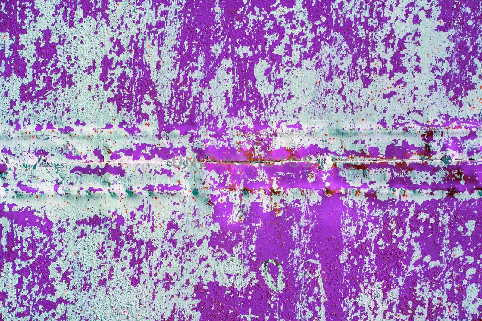 purple welded steel sheet wall with peeled off white paint under direct sunlight, full-frame background and texture.