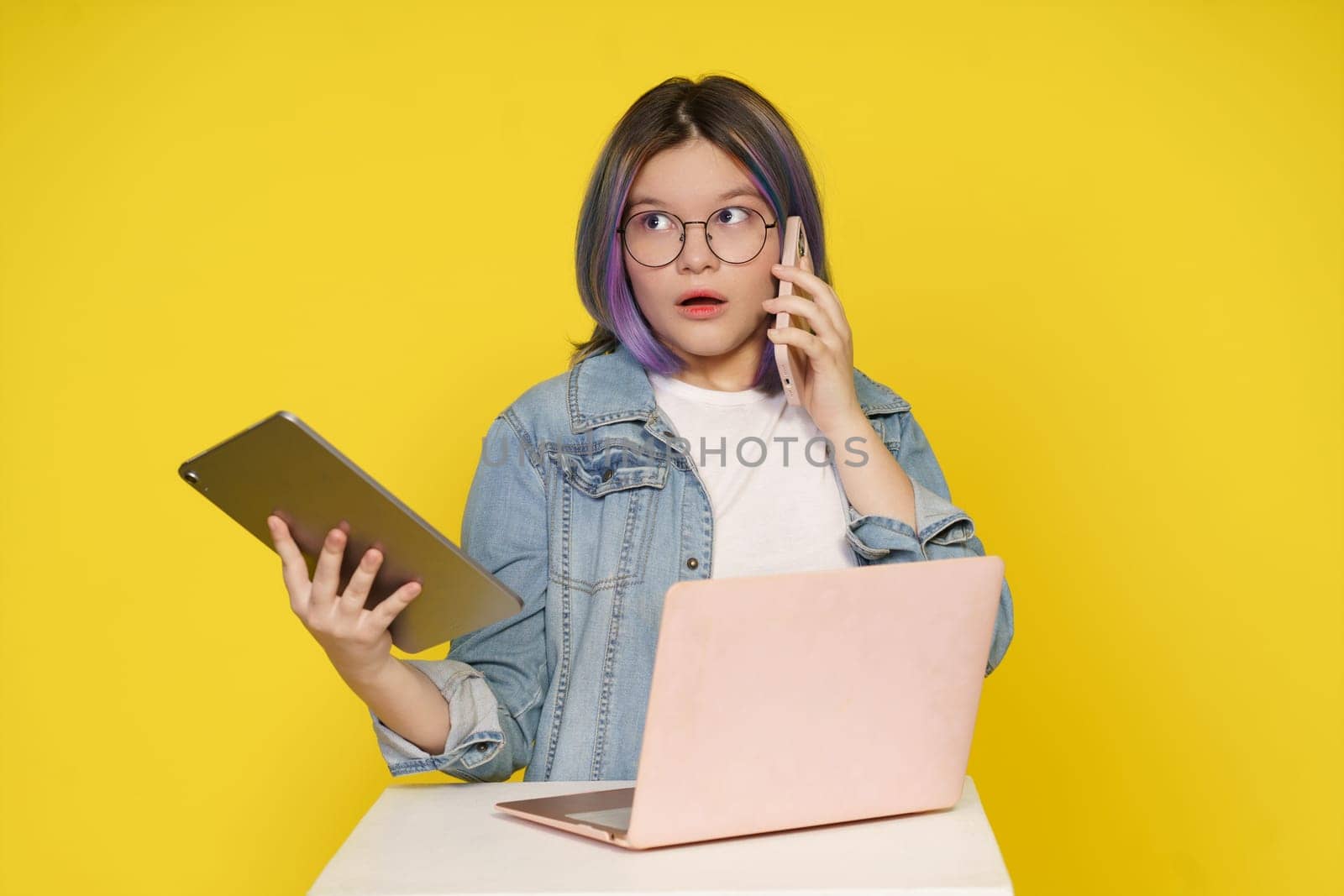 Quest For Information In Modern World, Girl Utilizes Laptop, Tablet Pc, And Mobile Phone To Conduct Online Research And Study. Contemporary Learning And Dynamic Use Of Digital Devices For Information Retrieval. by LipikStockMedia