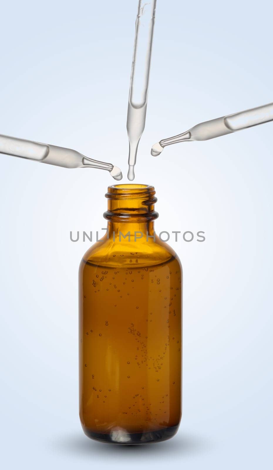A glass brown bottle with a dropper on a blue background, a container for cosmetic products. 