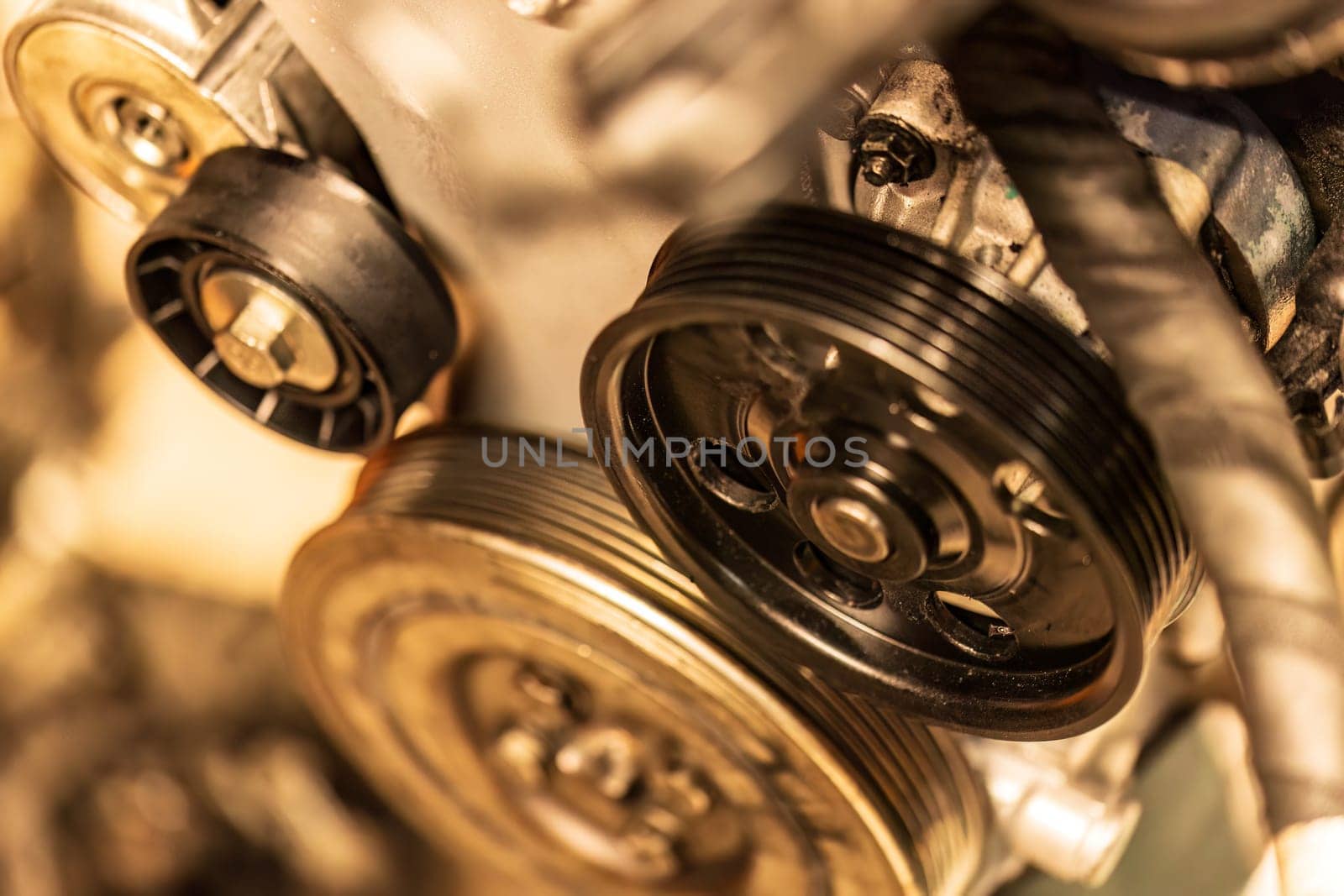 Photo focusing on the intricate pulleys of a car engine, highlighting their essential role in function.