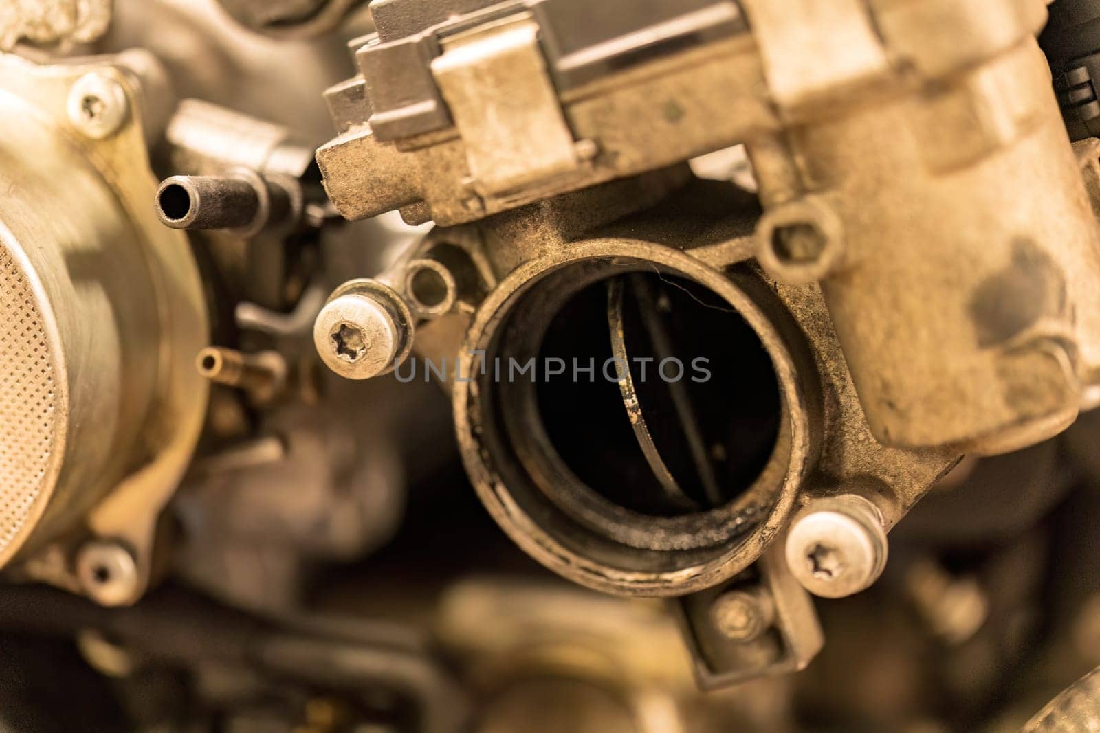 A photo capturing the gritty details of a dirty throttle valve within a car engine, showcasing wear.