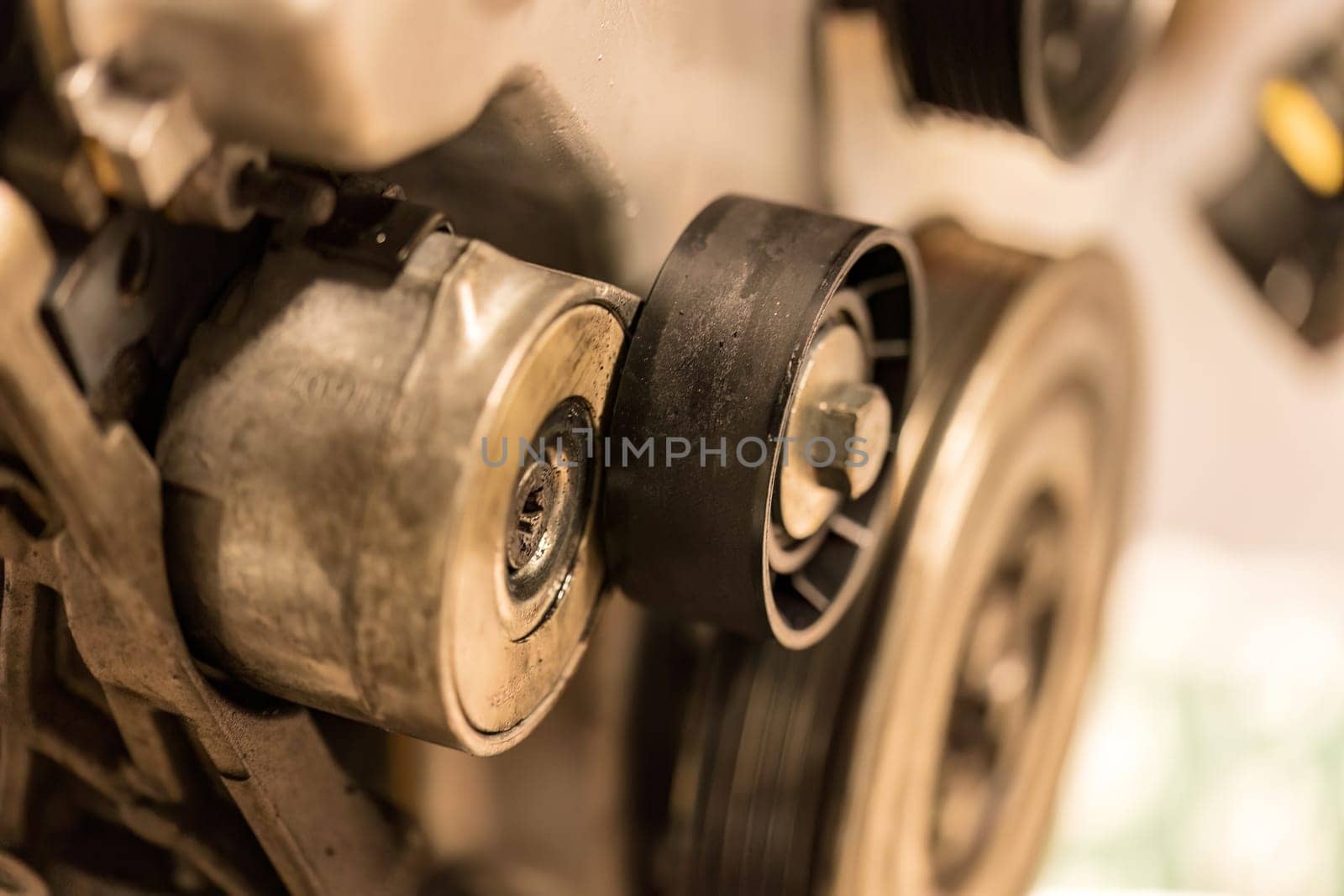 Photo focusing on the intricate pulleys of a car engine, highlighting their essential role in function.